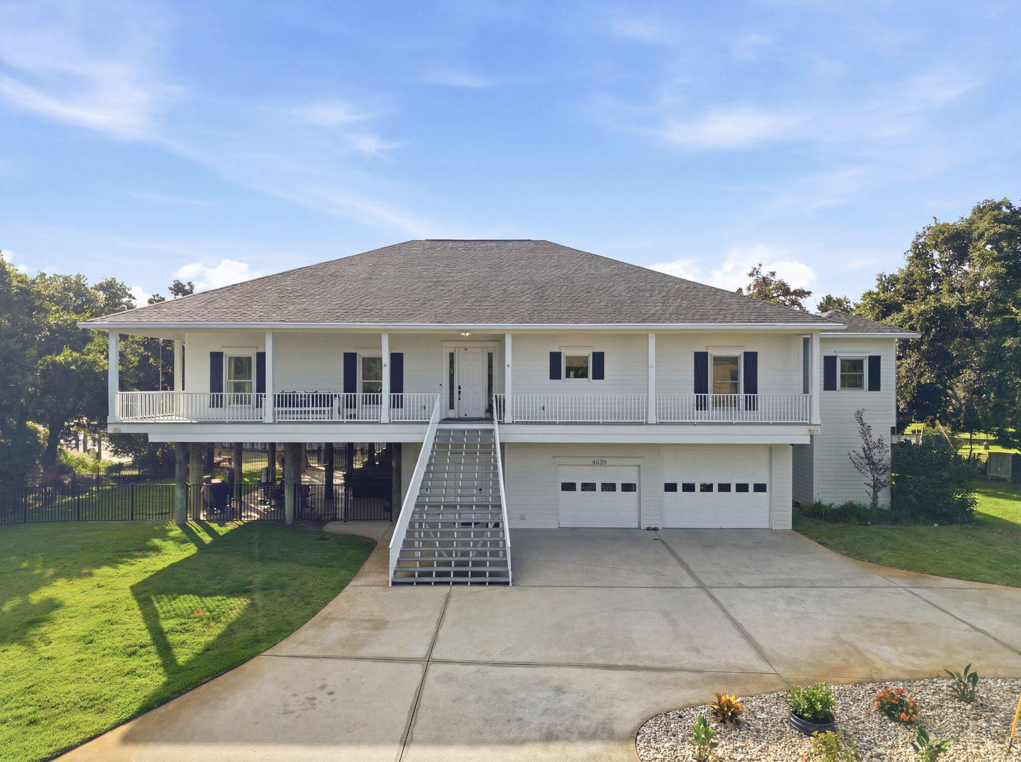 Perfectly positioned at the end of a quiet cul-de-sac and framed by mature oak trees, this exceptional waterfront home offers approximately 125 feet of deep-water bayou frontage, beautiful Santa Rosa Sound views, and convenient boating access. Blending privacy, comfort, and coastal-inspired updates, this property offers a truly distinctive waterfront lifestyle.

The entire main living area is conveniently situated on one level and is accessible by either the residential elevator or staircase. Expansive windows fill the home with natural light while framing beautiful water views throughout the main living areas.

The open floor plan seamlessly connects the living, dining, and kitchen spaces. The kitchen features custom cabinetry, granite countertops, stainless steel appliances, and bar-height seating.

The private owner's suite offers water views, a customized walk-in closet with built-ins, dual vanities, an oversized tiled walk-in shower, and an adjoining flex space ideal for a home office, reading room, or private retreat. Two additional bedrooms share a full bath. The oversized laundry room features white cabinetry, a utility sink, wine refrigerator, and additional storage.

Outdoor living truly shines with wraparound Trex decking spanning three sides of the home, a large screened porch, and a spacious ground-level covered entertaining area. A 2024 Bullfrog Spa conveys with the property.

Boating enthusiasts will appreciate the private covered boat lift, deep-water access, and quick access to Santa Rosa Sound. The oversized four-car garage, circular driveway, attached storage area, central vacuum system, spray foam insulation, Pella windows, and low-maintenance exterior finishes complete this exceptional waterfront home.