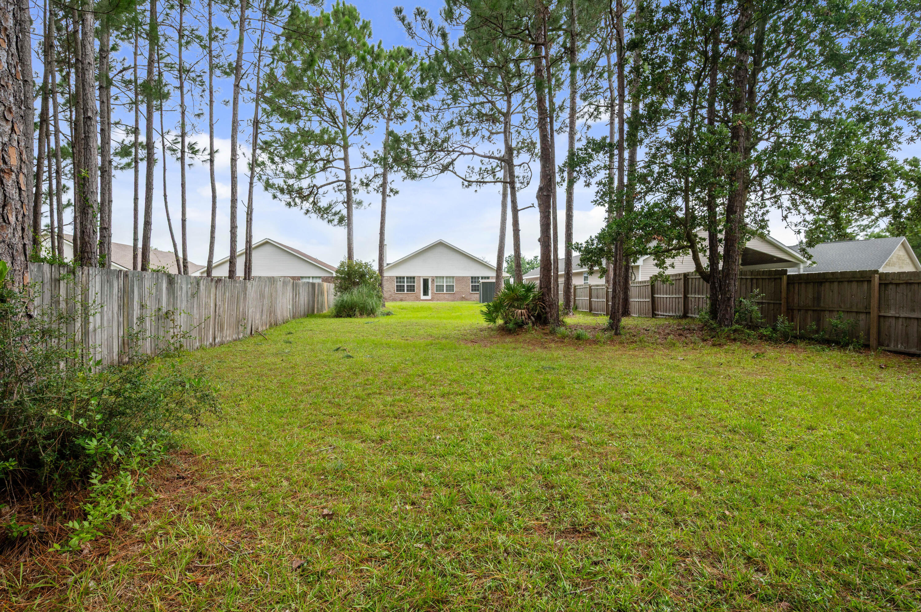 Welcome home to this immaculate all brick residence tucked on a quiet cul de sac in the highly desirable Whisperwoods Estates. Just 8 miles west of Hurlburt Field's main gate and 6 miles from the sugar white sands of Navarre Beach, this location is perfect for military families, beach lovers, and investors alike.
Step inside to find a bright, move in ready interior featuring fresh neutral paint and attractive laminate flooring throughout. Recent upgrades give this home true peace of mind: 2017 roof, 2017 energy efficient water heater, and a 2024 heat pump HVAC.  The kitchen shines with a newer dishwasher updated light fixtures and ceiling fans add a modern touch throughout.
Enjoy true privacy in the huge, fully fenced backyard, which backs up to wooded property, a rare find for nature lovers and anyone craving  space and seclusion. The yard also includes a convenient lawn irrigation pump and a small storage shed for extra gear. The garage boasts attic access stairs, giving you even more storage flexibility.
With sidewalks lining the peaceful cul de sac street, this home checks every box: great condition, unbeatable location, and a sweet price to match. Whether you're searching for your forever home or a smart investment property near Hurlburt Field and Navarre Beach, don't miss this Whisperwoods Estates gem backed by nature!