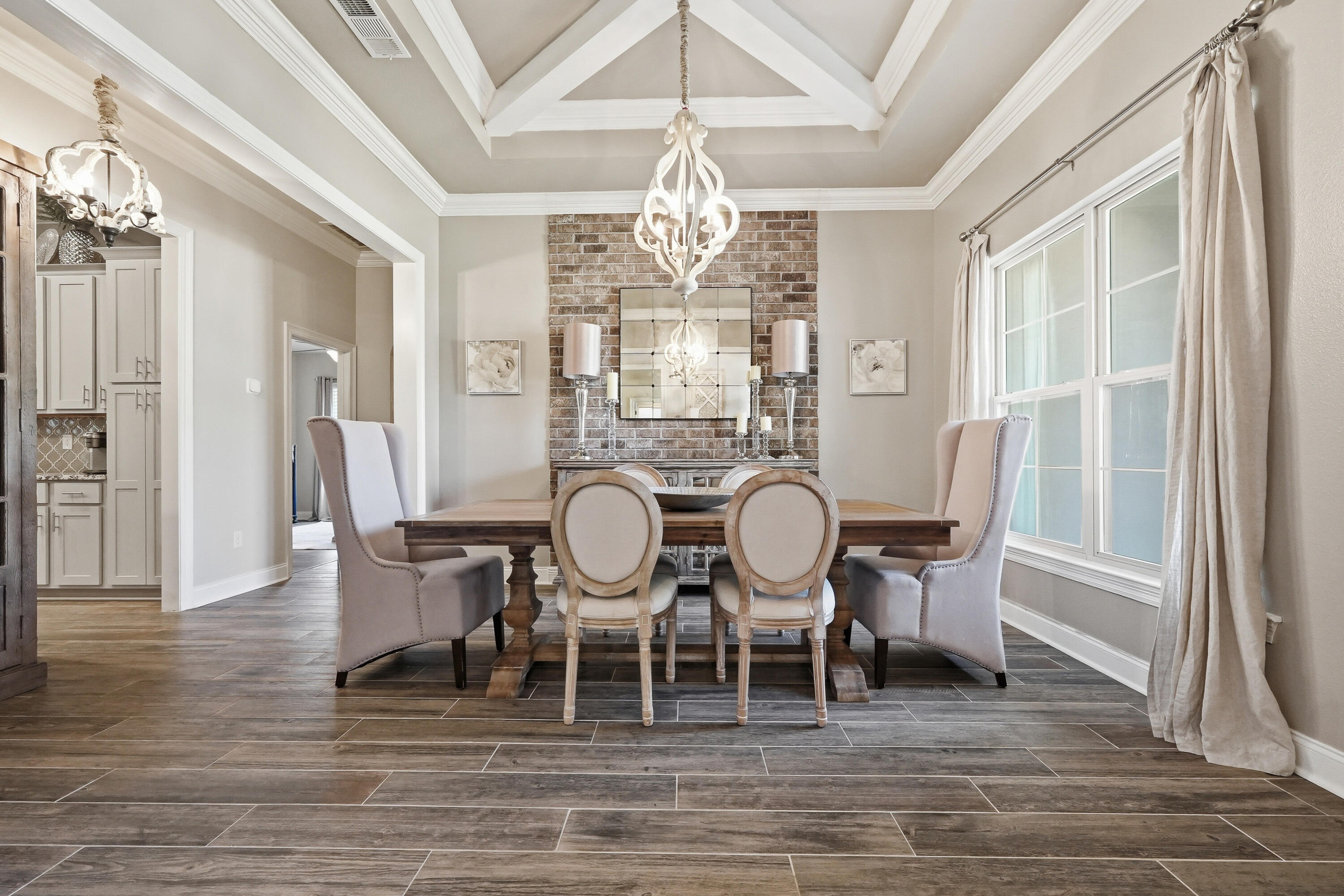 BEAUTIFUL, well-maintained home! This 4BR/3BA residence offers over 3,010 sq ft of thoughtfully designed living space, built in 2019 and ideally located just MINUTES from NAVY FEDERAL and the Shopping, dining, and medical conveniences of 9 Mile Rd. The Exterior showcases a timeless Brick & Stucco finish, seamless gutters, and professional landscaping for standout curb appeal. Inside, you'll find an open-concept layout with a FORMAL dining room and dedicated office, enhanced by COFFERED ceilings, crown molding, tray ceilings, Custom Lighting, FEATURE walls, and recessed lighting--creating a warm yet elevated feel throughout. The kitchen is a true centerpiece, featuring a LARGE granite island with bar seating, stainless steel appliances, tile backsplash, soft-close cabinetry, and a 5-burner gas range. The split floor plan offers privacy with three guest bedrooms and two full baths, including a convenient Jack-and-Jill layout. The SPACIOUS primary suite includes a sitting area, walk-in closet with direct laundry access, and a spa-like bath with double vanities, soaking tub, and tiled WALK-IN Shower. Enjoy year-round relaxation in the screened-in SUNROOM with ceiling fans and full electrical--perfect for entertaining or unwinding. Additional highlights include CUSTOM LIGHTING, heated and cooled oversized 2-car garage with a painted floor.