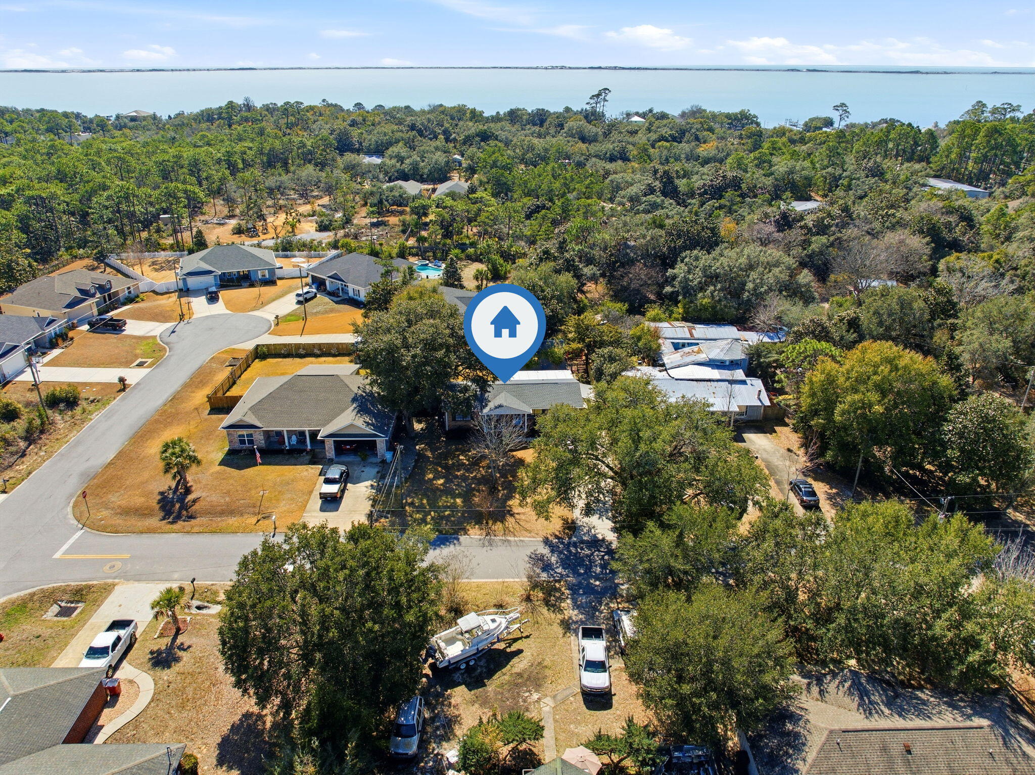Welcome to Bonanza--where charm, flexibility, and Emerald Coast lifestyle come together.

You will absolutely fall in love with this adorable and well-maintained three-bedroom home, perfectly positioned near the water without being in a flood zone.

From the moment you arrive, the pride of ownership is undeniable. The property is fully fenced with a deep driveway and beautifully maintained landscaping, complete with mature plants, shrubs, and thoughtful stepping-stone details that immediately make you feel at home. Inside, you'll find an updated kitchen with all appliances conveying, opening into a cozy and inviting living space. A convenient bump-out area provides the perfect spot for a home office, just around the corner from the stackable laundry area (washer and dryer are negotiable). The former garage has been professionally converted into additional living space, creating a welcoming breakfast or formal dining area as you enter the home.

Recent updates include fresh paint, updated doors, and flooring throughout. Step outside to discover a large powered workshop ideal for a true workshop, hobby space, or easily convertible into a mother-in-law suite. The extended patio offers plenty of shade, making it perfect for relaxing summer evenings.

The lot provides additional footprint for future expansion, allowing for more bedrooms or bathrooms if desired. With no HOA, there's ample room for RV parking and recreational toys yes, bring the boat! Enjoy casual strolls down the road for water views, easy boat launching, and a laid-back coastal lifestyle ideal for pets, kids, and outdoor enthusiasts.

All of this near the water, outside the flood zone, no HOA, and incredible flexibility at an attractive Emerald Coast price point. The sellers are also offering a flexible closing timeline.

Back on the market at no fault of the sellers, buyers financing fell through.