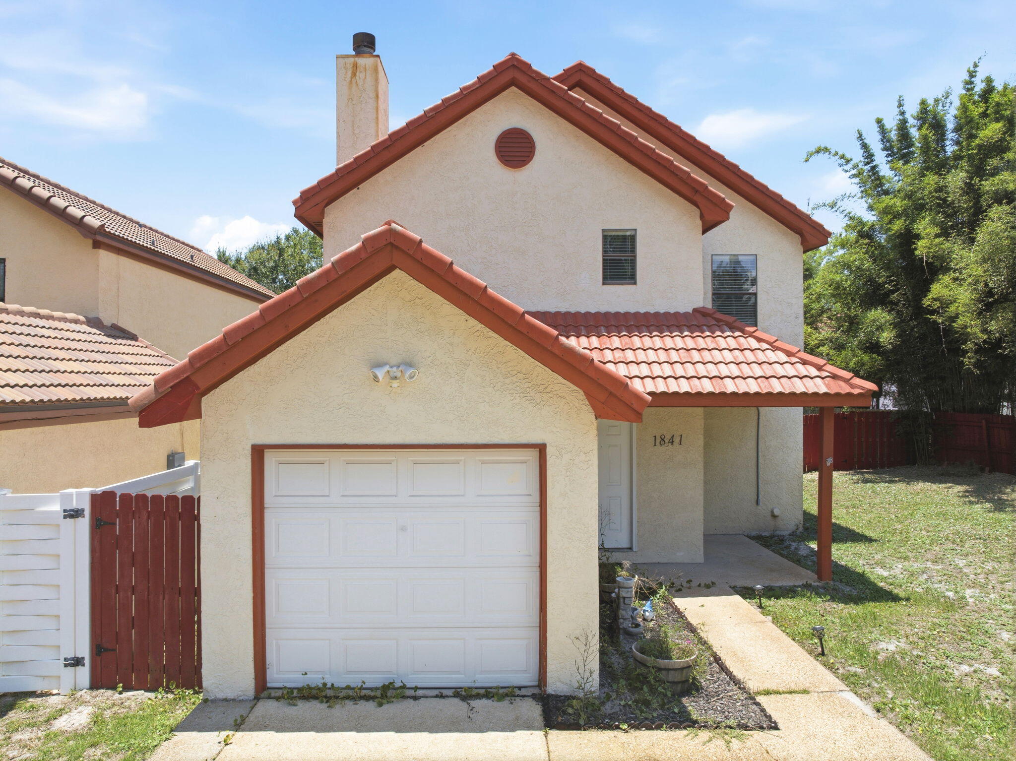Welcome to this charming Mediterranean-style home in the Smugglers Cove neighborhood in Gulf Breeze. Located in Midway - just 15 minutes to the sandy white beaches of either Navarre or Pensacola Beach! Enjoy all the community amenities, including a sparkling pool, tennis and pickleball courts, community room, and deeded water access to the Santa Rosa Sound via a private community boat launch and pier! This 3 bedroom, 2 and a half bathroom home offers 1,514 SqFt and 2 levels of living space. The 1st floor hosts the main living area with beautiful tiled flooring throughout. The living room features a cozy wood-burning fireplace and flows directly into the dining and kitchen areas. The kitchen offers all black and stainless appliances, granite countertops, ample cabinets and counterspace, and a breakfast bar that overlooks the dining area. Up the staircase to the bedrooms, notice the functional and beautiful cathedral ceiling and windows to let in tons of natural light. The second level features gorgeous hardwood floors with tile in the bathrooms. The primary suite has its own en-suite with double vanity, water closet, and walk-in closet. Step outside to the covered patio and the fenced-in backyard that leads you to your very own deck situated on one of the community ponds - perfect for relaxing with your morning cup of coffee while taking in the views of your nature oasis. Schedule your showing today, and come see for yourself!