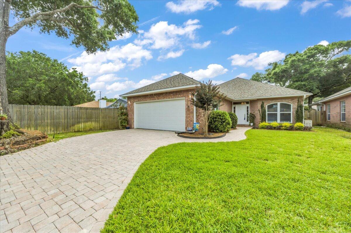 Nestled at the end of a cul-de-sac in the desirable Enclave East neighborhood, this brick home offers a brand new kitchen, plenty of updates (see MLS docs for full list) and a lanai for fabulous outdoor living! Key components have already been addressed, including a whole-home generator, a six-year-old roof and HVAC system, and a one-year-old gas water heater. Inside, you'll find a newly updated kitchen that checks all the boxes! Designed with both beauty and functionality in mind, it features quartz countertops, a GE Café double-oven range, built-in microwave, abundant floor-to-ceiling stacked cabinetry, a hidden coffee station, and a concealed TV cabinet. The oversized breakfast bar provides additional seating and incorporates extra storage beneath. The spacious living room is filled with character, boasting soaring vaulted ceilings, a cozy fireplace, and windows adorned with plantation shutters. The split-bedroom floor plan offers privacy, with the primary suite tucked away on its own side of the home. This inviting retreat features vaulted ceilings, decorative plant ledges, a walk-in closet, and an ensuite bath with dual vanities and a new walk-in shower. Two additional bedrooms and a full bath are located on the opposite side of the home. Step outside to a backyard designed for relaxation and easy maintenance! The expansive screened birdcage lanai creates the perfect setting for entertaining or unwinding, while the retractable awning provides additional shade on sunny af ternoons. Artificial turf allows more time for enjoying your outdoor space and less time on upkeep. Additional highlights include a dedicated laundry room and two-car garage. Enjoy the convenience of being minutes from Pensacola International Airport, shopping, dining, hospitals, and only about 20 minutes from the white-sand beaches of Pensacola Beach. Lovingly cared for and move-in ready, this home offers peace of mind and exceptional quality in one of Pensacola's most convenient locations!