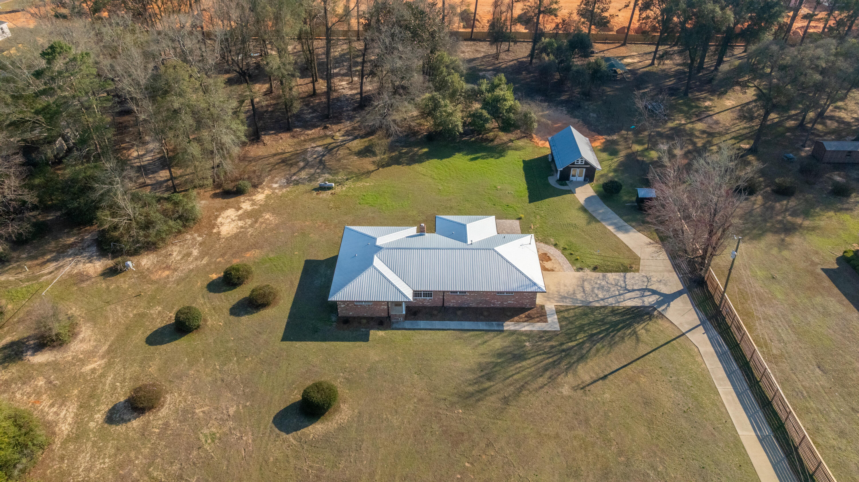 Beautifully updated brick home on 2 acres with new upgrades galore including a metal roof, tankless water heater, stainless appliances, septic system, and washer and dryer. Powered workshop, generator hook-up, and more! Multiple living areas include a heated and cooled sunroom (not in square footage.) Check out the barndominium/guest cottage on property...so much potential on this 2-acre property!!! The guest cottage offers an open concept living area, loft, kitchenette, bathroom, and laundry room with washer and dryer included-ideal for guests, extended family, or rental income.  

This is a true gem in Crestview and the attention to detail in bringing this home to market shines.  Schedule a showing today!