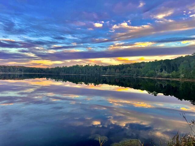 BEAUTIFUL WATERFRONT LOT ON SEACOAST LAKE (also known as Little Lake Holly), just a few minutes north of DeFuniak Springs. This 1.36 acre wooded lot offers plenty of privacy to build your dream home. The lot faces due west, so get ready for spectacular sunset views over the water. The 43 acre spring fed lake offers clear natural spring water and great fishing opportunities. There is an HOA associated with this development assuring that the lot and the surrounding properties will maintain quality construction, appearance & maintenance of common areas and the lake itself. The S/D offers a large paved common area with boat launches to both Seacoast Lake & Lake Holly.  A city water line and underground utilities are already in place. Seller states that a reduced tap fee with the City has been negotiated. Build here and enjoy quiet country living just a few minutes from DeFuniak Springs and only 40 minutes from our white-sand Gulf beaches!