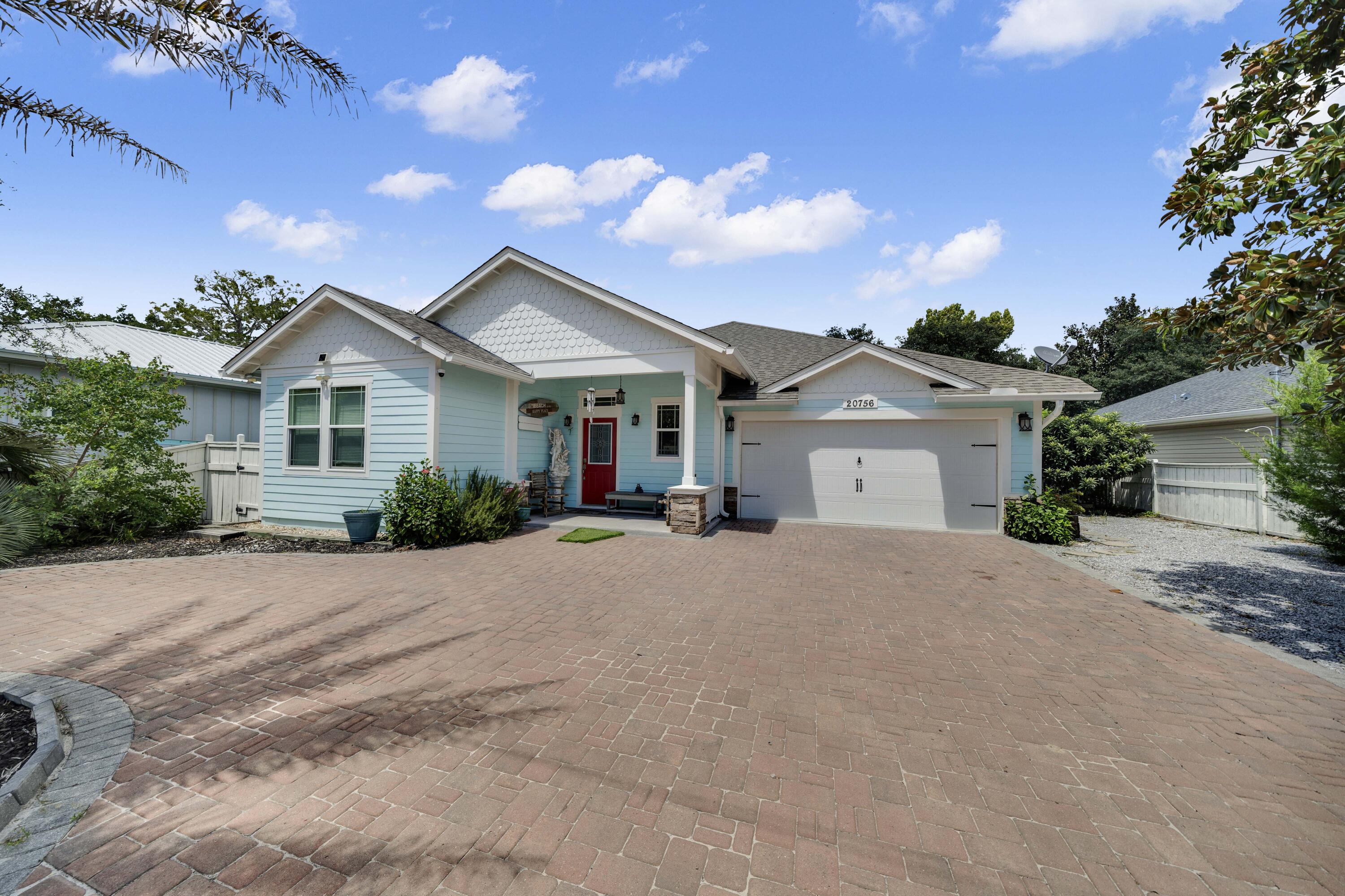 Experience the best of beach living in this custom-built Laguna Beach retreat. 

Located just a short walk from the sugar-white sands and emerald waters of the Gulf, this custom-built 3-bedroom, 2.5-bath home offers 1,882 square feet of living space, including a bonus sunroom. Situated on a quiet dead-end street in the golf-cart-friendly community of Laguna Beach, the property combines quality construction, strong rental potential, and ample parking. 

The home's south-facing orientation fills the interior with natural light and provides beautiful sunrise and sunset views throughout the year. Built with 2x6 exterior walls, impact windows, Hardie Board siding, architectural shingles, paver driveway, and premium roof decking, the home was designed for durability and low maintenance. 

The split-bedroom floor plan features an open living area and a well-appointed kitchen with walk-in pantry, KitchenAid stainless appliances with wall oven, a Bosch dishwasher, custom hood vent, and a beautiful sea-blue backsplash.  Ideal for a primary residence or second home, the property includes a covered front porch, a two-car garage, extra parking for multiple vehicles, and space for a boat, RV, trailer, or golf cart. With no HOA and short-term rentals allowed, it offers flexibility for both full-time living and investment use. 

The fenced backyard features an outdoor shower, large deck and patio, ample room for a resort-style pool, and a custom gazebo constructed from exotic Ipe wood imported from South America, creating a unique outdoor living and entertaining space. Additional features include a wood-burning fireplace with stone surround, heated bathroom exhaust fans, rain-head walk-in showers, custom built-in shelving, and a bay window in the primary bedroom overlooking the backyard. 

Located near public beach access #84, the home is conveniently located within a 10-minute drive either way between Pier Park and the 30A corridor near Rosemary Beach, providing easy access to shopping, dining, entertainment, and the beach. 

Buyer to verify all data and dimensions if important as some measurements are approximate.
