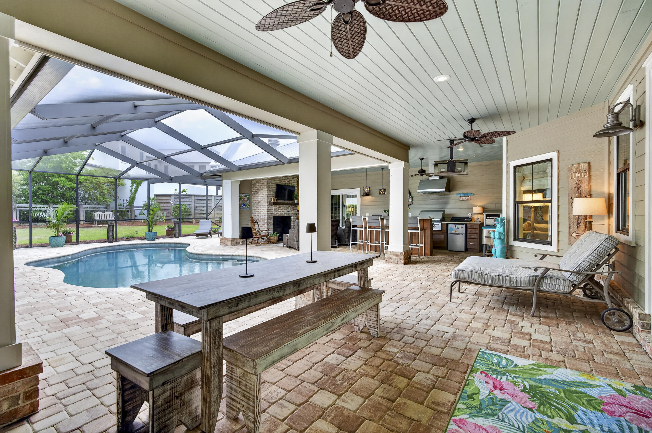 A rare opportunity to own a luxury coastal retreat with STRONG INVESTMENT appeal and no HOA restrictions in one of 30A's most sought-after locations in the heart of Old Seagrove Beach, this exceptional property captures the essence of elevated 30A living. Perfectly positioned on an oversized corner lot at the end of a quiet cul-de-sac, this meticulously maintained residence offers the ultimate blend of privacy, space, and walkability--where golf carts are a welcomed. With no HOA and convenient walking access to two beach easements leading to the Azalea and Gardenia entrances, as well as the 395 access, the location is simply unmatched. Enjoy biking, walking, or cruising to Seaside, Publix, and 30A's most sought-after dining and shopping. Designed to live like a primary residence yet perfectly suited as a second home or short-term rental, this meticulously cared-for property delivers a true resort-style experience. The private, fenced backyard is a special treat featuring large area of space to play. At the center of the home, an incredible outdoor living space creates the ultimate entertaining environment--complete with a resort-style pool and fountain, fully equipped outdoor kitchen and bar with grill, refrigerator, icemaker, pizza oven, sink, and ample storage. A dining area, half bath, enclosed outdoor shower, and a cozy living space with a brick fireplace make this courtyard a year-round retreat, all protected by a screened enclosure with newer screens for added comfort and durability. Seasonal panels allow for enclosed winter entertaining, adding even more versatility.

Inside, the home welcomes you with a private foyer. To one side, two guest bedrooms are connected by a Jack-and-Jill bath, both with direct access to the pool area. On the opposite side of the foyer, an additional bedroom and bath for guests. The exceptional oversized two-car garage opens into a thoughtfully designed mudroom with built-in storage, sink, folding space, and a large stackable washer and dryer--perfect for beach living.

The main living area is open, inviting, and designed for gathering. A spacious dining area easily accommodates eight or more guests and flows seamlessly into the living room, anchored by a stunning double-sided stone fireplace and a stylish wet bar with glass storage, wine rack, and mini fridge. The well-appointed kitchen features a large island with bar seating, abundant workspace, and a cozy keeping room with the fireplace's second side--creating warmth and connection throughout the space.

The rear of the home offers a generous guest suite with private bath, along with the added bonus of a second full laundry room. Just beyond, you'll find an expansive primary suite retreat featuring private sliders that open directly to the outdoor living area. The luxurious primary bath is designed for relaxation, highlighted by a spa-like steam shower that elevates the everyday experience.

Additional highlights include a whole-house Generac generator for peace of mind, extra parking, and a well-maintained paver driveway. Every detail has been thoughtfully curated, making this far from your ordinary beach home. Whether you're seeking a full-time residence, vacation retreat, or investment opportunity, this Seagrove gem captures the essence of elevated coastal living. Last but not least newer screens over the outdoor living and a well for your exterior irrigation.