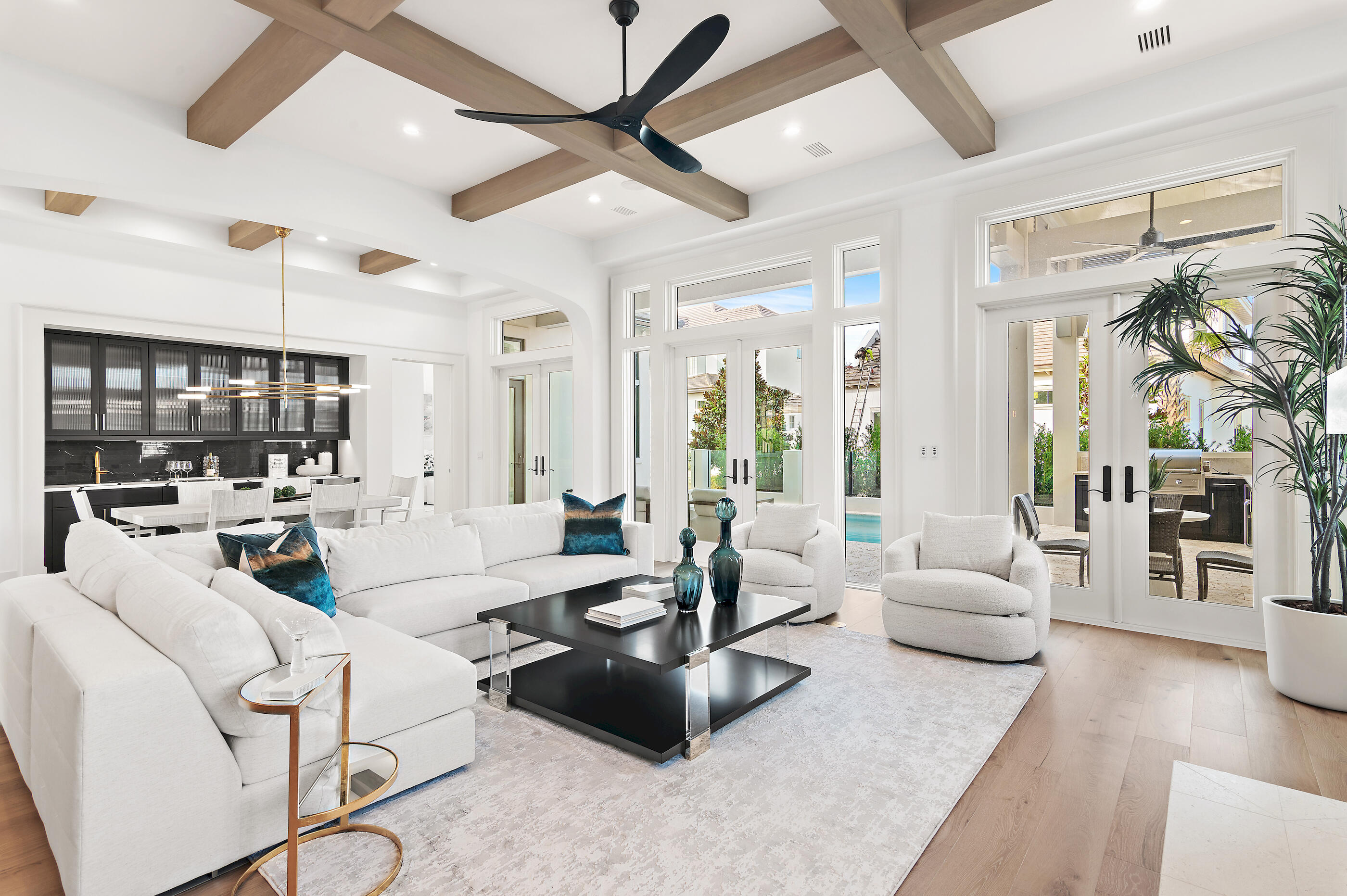 Less than a mile from the beach! Finishes and details are stunning! Introducing Tradewinds, the latest gem in Regatta Bay, featuring 54 exquisite homesites inspired by the architectural elegance of the West Indies and Dutch styles. This stunning, brand-new residence embodies modern luxury, seamlessly blending indoor and outdoor living across over 3,600 square feet of climate-controlled space. It boasts 4 bedrooms, 4 full bathrooms, and 2 additional half baths. Upon entry, you are immediately captivated by the design, featuring wood beams on the ceiling and gracefully curved arches. The home presents a sophisticated black-and-white theme, enhanced by tasteful tile selections in the kitchen, butler's pantry, wet bar, and bathrooms. The home boasts an inviting open floor plan, highlighted by a spacious living room featuring a cozy fireplace and a gourmet chef's kitchen equipped with top-of-the-line amenities. On the first floor, the master bedroom provides breathtaking views and direct access to the outdoor living area. The master bath showcases double vanities, elegantly designed lighting fixtures, a custom walk-in tiled shower, and a luxurious soaking tub. Adjacent to the master bedroom, a generous walk-in closet offers custom shelving and his-and-her drawers for added storage. Also located on the first floor is a convenient powder bath for guests, a wet bar, and a guest suite complete with its own private bath. Upstairs, you will discover a generous bonus room, an extra wet bar, two guest suites each featuring private baths, a sizable storage or multipurpose room, and an expansive balcony. The exterior showcases an inviting outdoor area, complete with a summer kitchen and a picturesque Alys Beach-style pool, making this home an ideal retreat for relaxation and entertainment. Built by Legendary Home Builders, utilizing only the finest materials and high end finishes such as: wind and impact resistant windows, wind and impact rated doors, insulated wind and impact rated garage doors, insulation in all interior walls for energy efficiency, sound proofing insulation between floors for sound barrier, stainless steel door hinges, custom wood shelving in all closets, Kohler plumbing throughout, custom solid wood cabinetry throughout with soft close hinges, surround sound, smart home technology customizable for homeowner, led lighting throughout and so much more...