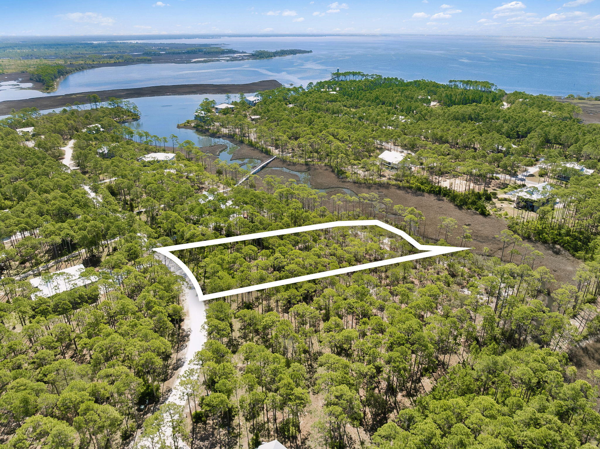Positioned along the waterfront in the sought-after RiverCamps community, 6315 Turkey Cove Lane offers a rare opportunity to build a custom home on 1.6 acres, surrounded by protected natural beauty, mature oaks, and sweeping views toward West Bay. 

This premium homesite combines privacy, scale, and waterfront living within one of the most unique gated communities in the Florida Panhandle. 

Adding significant value for the next owner, the seller has already completed, survey, soil testing and an elevation certificate, helping streamline the building process and potentially saving both time and upfront costs. Custom home plans may also convey with the sale. RiverCamps is unlike any other community in the area, spanning roughly 1,500 acres bordered by Crooked Creek, West Bay, and the Intracoastal Waterway. 

Only 450 homesites are spread across approximately 500 acres, while the remaining 1,000 acres are dedicated to conservation. The result is a low-density, outdoor-focused community centered around nature, privacy, and waterfront living. 

Residents enjoy access to a waterfront pool, fitness center (under construction), boat ramp, day-use boat slips, dry boat storage, kayaks, paddleboards, walking trails, and the renowned RiverHouse (being re-developed) overlooking Crooked Creek. Conveniently located near Panama City Beach, Northwest Florida Beaches International Airport, and the beaches of 30A, RiverCamps offers a rare balance of seclusion and accessibility.