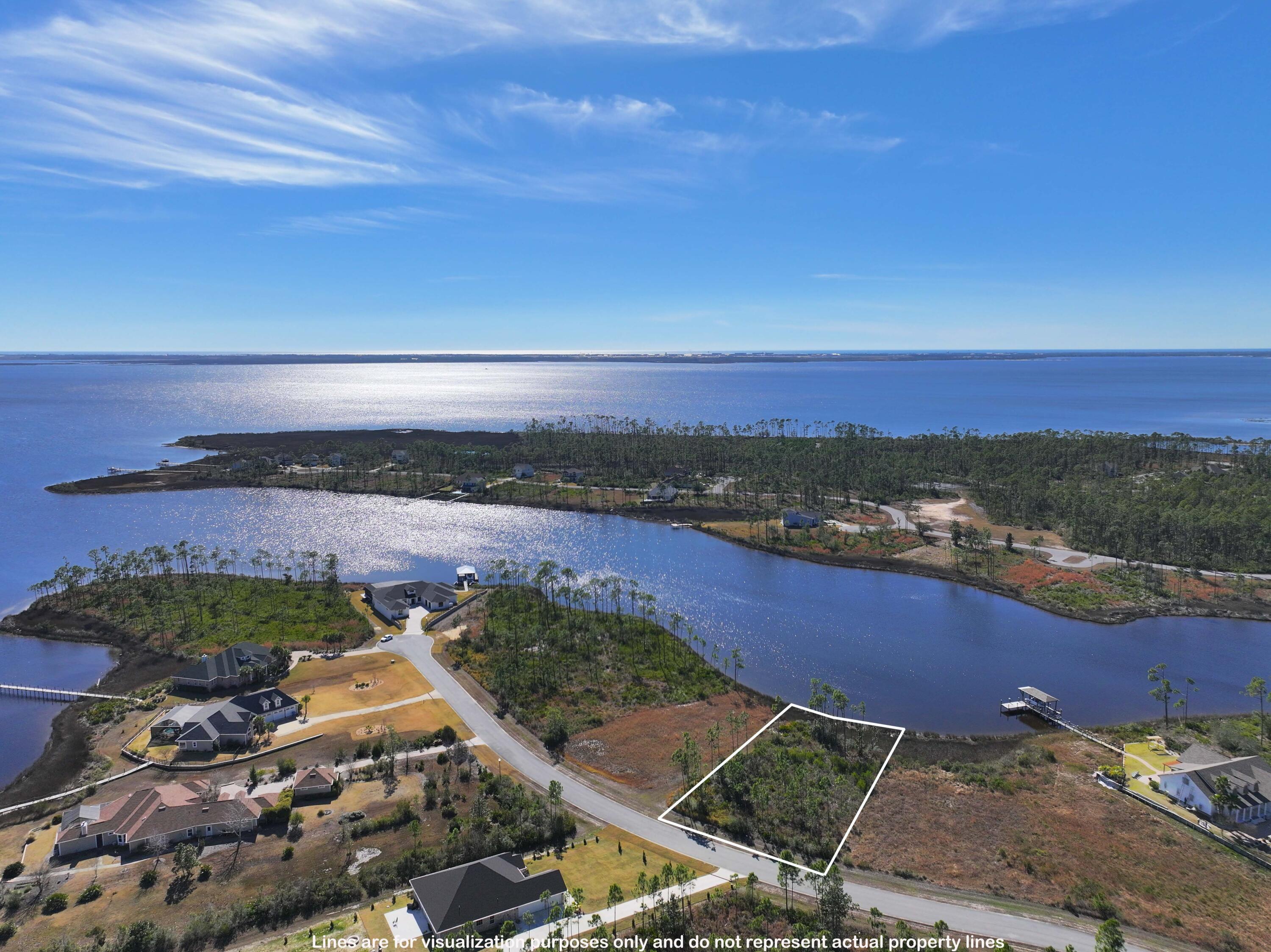 Unbelievable views in this Nature Lover's Paradise! This secluded waterfront lot has bayou access and is located directly on Laird Bayou in the beautiful gated community of Laird Bayou. Only minutes away from the Gulf of Mexico by boat! Residents are rewarded with an irresistible combination of natural beauty and convenience to the beaches, restaurants and attractions. Approximately a 15-minute drive to Tyndall AFB. Laird Bayou Residents have amenities such as a beautiful community pool, gated boat & RV storage and a private boat launch & dock! Perfect for boaters, anglers and all who delight in nature's coastal beauty. Buyer to verify all lot dimensions and due diligence on water depth and dock permitting.