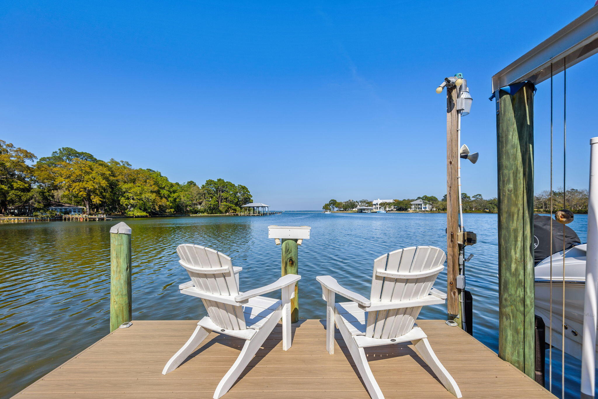 Welcome to Sacred Oaks, a waterfront community on Mack Bayou.  An exceptional private retreat nestled in the heart of Santa Rosa Beach, this beautifully appointed residence offers the perfect blend of refined elegance and Southern Charm.  The brick paved streets and driveway with French gas lanterns at the entry are shaded with moss-draped oaks and views of the deep water bayou that opens up to the Choctawhatchee Bay, two boat docks with lifts, two jet ski lifts and a new salt water swimming pool captures the dream of Florida coastal living.  Inside you'll find an elevator, engineered wood floors throughout and updated features including expanded upper level windows to take in the panaramic waterview.  The kitchen is appointed with granite countertops and modern appliances and is fully equipped with natural gas (stove, pool heater, fireplace and tankless water heater), Culligan water treatment system, and modern smart-home convenience.  A brand-new seawall, full-property irrigation system and a newly fenced pool area with it's own lot totaling rare bayou frontage of 90'.  Additional bedrooms are generously sized offering flexibility for guests, a home office, or a growing family. Step outside to enjoy expansive porches and outdoor areas perfect for morning coffee or simply soaking in the coastal breeze. Conveniently located to Sandestin Beach Resort and Grand Blvd. with dining and shopping, access to world-class golf courses, scenic bike paths on 30A and the beautiful white sandy beaches of South Walton are a few minutes away.  This property consists of two lots, #19 with the house and #20 with the pool so a total of 90' waterfront.