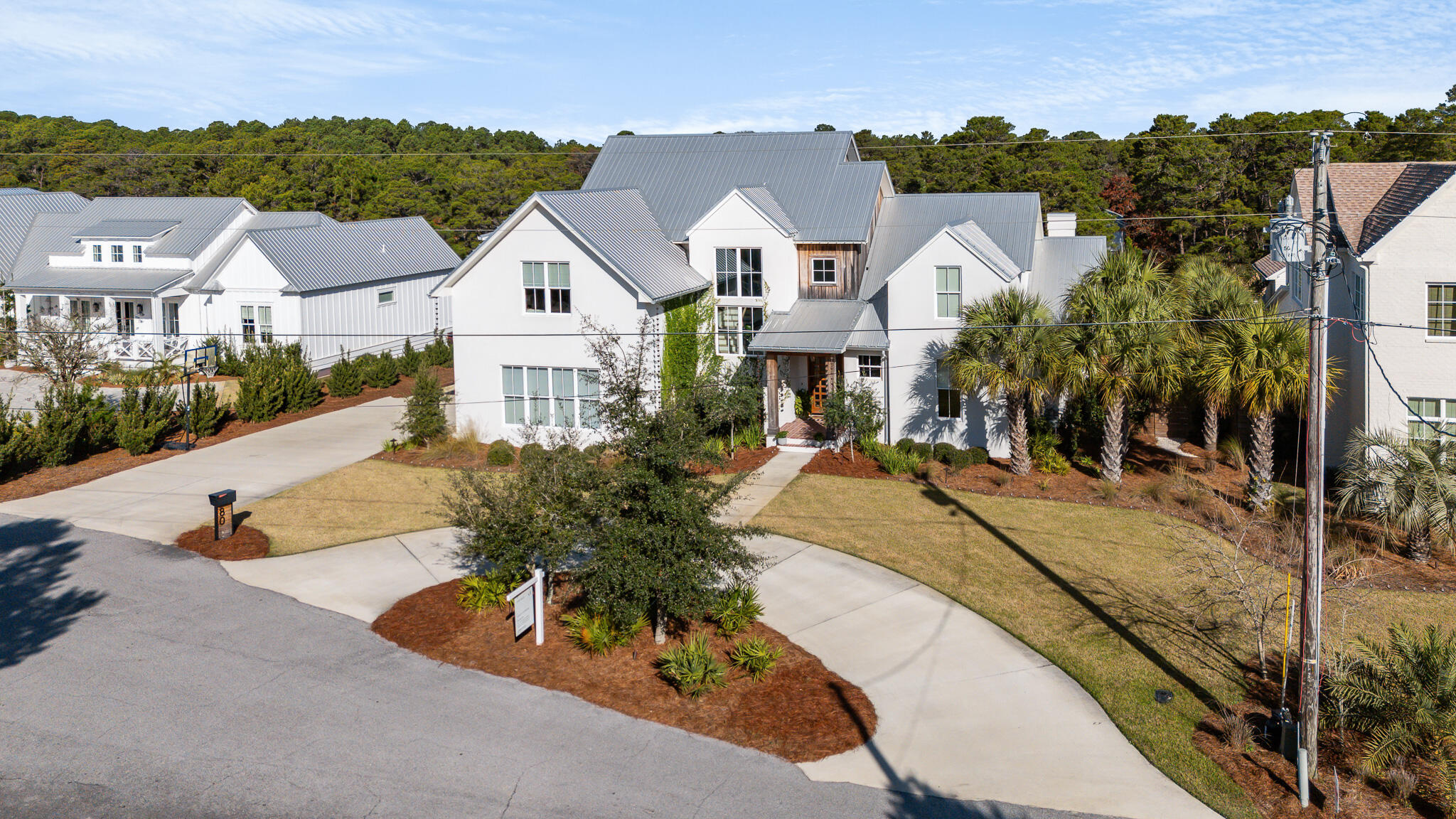 At the end of a quiet cul-de-sac in Santa Rosa Beach, 80 W Blue Coral Drive delivers the kind of modern coastal living high-end buyers want right now: clean design, smart function, and a backyard that truly lives like a private resort. From the moment you arrive, the home makes a strong first impression with a circular drive, a side-entry two-car garage, and extra guest parking, an estate-style setup that immediately elevates both everyday living and entertaining. Inside, the architecture is all about volume, light, and flow. Built in 2022, the open-concept plan feels tailored and intentional, with the kitchen positioned as the showpiece at the heart of the home. Quartzite Taj Mahal countertops bring a soft, elevated warmth to the space, paired with ceiling-height cabinetry and a statement island that's equal parts beautiful and hardworking. A butler's pantry adds serious convenience with custom cabinetry and an extra refrigerator, making hosting and daily life feel effortless.

The family room is equally impressive, featuring vaulted ceilings with custom wood beams, a fireplace, and built-ins that create a true focal point while still feeling inviting. For buyers who need a work-from-home space or just want a quiet retreat, the main-level office or study includes custom built-ins, offering function without sacrificing style.

That indoor outdoor connection is where the lifestyle really comes alive. Step outside to a screened-in patio that feels like a second living room, complete with a summer kitchen and fireplaceperfect for game days, cozy winter nights, and long summer dinners. Beyond, the property opens into a resort-like setting: a sparkling pool, large deck, and spacious yard designed for long afternoons and easy evenings. The in-ground trampoline adds an unexpected, family-forward touch that still feels elevated, because luxury isn't just how a home looks, it's how well it supports real life.

The primary suite on the main level is a standout for both comfort and resale appeal, offering privacy and a true spa-style bath: heated floors, dual vanity, soaking tub, oversized tiled shower, and a water closet. Even better, the layout flows naturally to outdoor living, plus there's access to an outdoor shower, making beach days and pool days feel seamless. A mudroom with built-in lockers keeps the day-to-day organized and polished, especially for busy households.

Upstairs, the secondary bedrooms are thoughtfully arranged for flexibility, with one bedroom featuring its own bath and others connected via a Jack and Jill. A loft style landing adds extra breathing room and makes a perfect spot for a reading nook, homework zone, or casual hangout space.

Just minutes from the shoreline and the signature energy of 30A's dining, boutiques, and beach days, this home pairs newer construction quality with an editorial level of finish and one of the most desirable extras in today's market: a backyard experience that feels like a private club, without the fees. For buyers seeking a primary residence, a second home, or a high-end lifestyle property with long-term value, 80 W Blue Coral Drive stands out as a polished, turnkey option in a location that continues to command attention.
