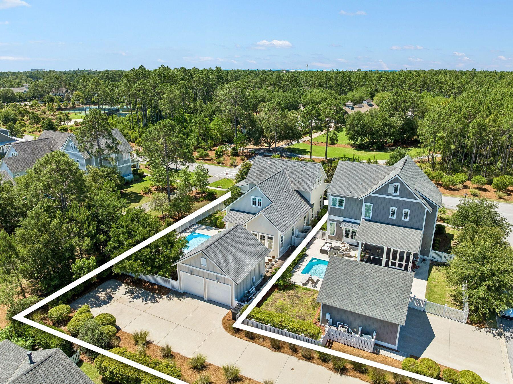 Positioned directly across from the amenity center in WaterSound Origins, this thoughtfully designed residence is uniquely buffered by lush landscaping and a scenic walking trail, creating an unexpected sense of privacy and separation while remaining in the heart of the community's amenities. Framed by mature greenery and natural common space, the home enjoys a tranquil setting with immediate access to the clubhouse, fitness center, resort-style pool, tennis and pickleball courts, playground, and the acclaimed Origins Golf Course. The result is a rare balance of convenience, seclusion, and exceptional indoor-outdoor living in one of 30A's most desirable communities. Designed for both everyday comfort and effortless entertaining, the home features expansive covered porches with exceptional depth, including a screened side porch off the kitchen that overlooks the common green space and flows seamlessly to the private pool and hot tub. A detached rear-entry two-car garage allows for an uncommon amount of additional parking while preserving the home's charming streetscape and curb appeal. Inside, wire-brushed wood flooring, custom draperies, and elevated finishes create a warm yet refined aesthetic. The first floor is anchored by 12-foot ceilings and an open-concept living, dining, and kitchen area filled with natural light. The kitchen offers quartz countertops, a large center island, gas range, and a custom range hood accented with vintage mirror detailing. Just beyond, the laundry room features marble countertops and transitions into a beautifully designed office nook with grasscloth wall coverings. A first-floor powder bath adds convenience for guests. The primary suite is privately situated on the first floor and offers a spacious retreat complete with dual vanities, soaking tub, and separate his-and-hers walk-in closets. Upstairs, three guest suites each feature their own ensuite bath, while a built-in hallway bunk area with two twin-over-twin bunks provides additional accommodations ideal for family and guests. Residents of WaterSound Origins enjoy an exceptional lifestyle centered around outdoor recreation, wellness, and community, with access to the Origins Golf Course, tennis and pickleball courts, fitness center, miles of walking trails, playground, and a resort-style zero-entry pool designed for gathering and relaxation. Owners also have the convenient option to further elevate their experience through membership opportunities with WaterSound Club, offering access to an unmatched collection of private amenities along the Emerald Coast. Club members enjoy three 18-hole golf courses, the private Beach Club with gulf-front dining and beachfront pools, and the Camp Creek amenities featuring eight tennis courts, resort-style zero-entry and adult pools, a lazy river, state-of-the-art fitness center, wellness facilities, and on-site dining venues.