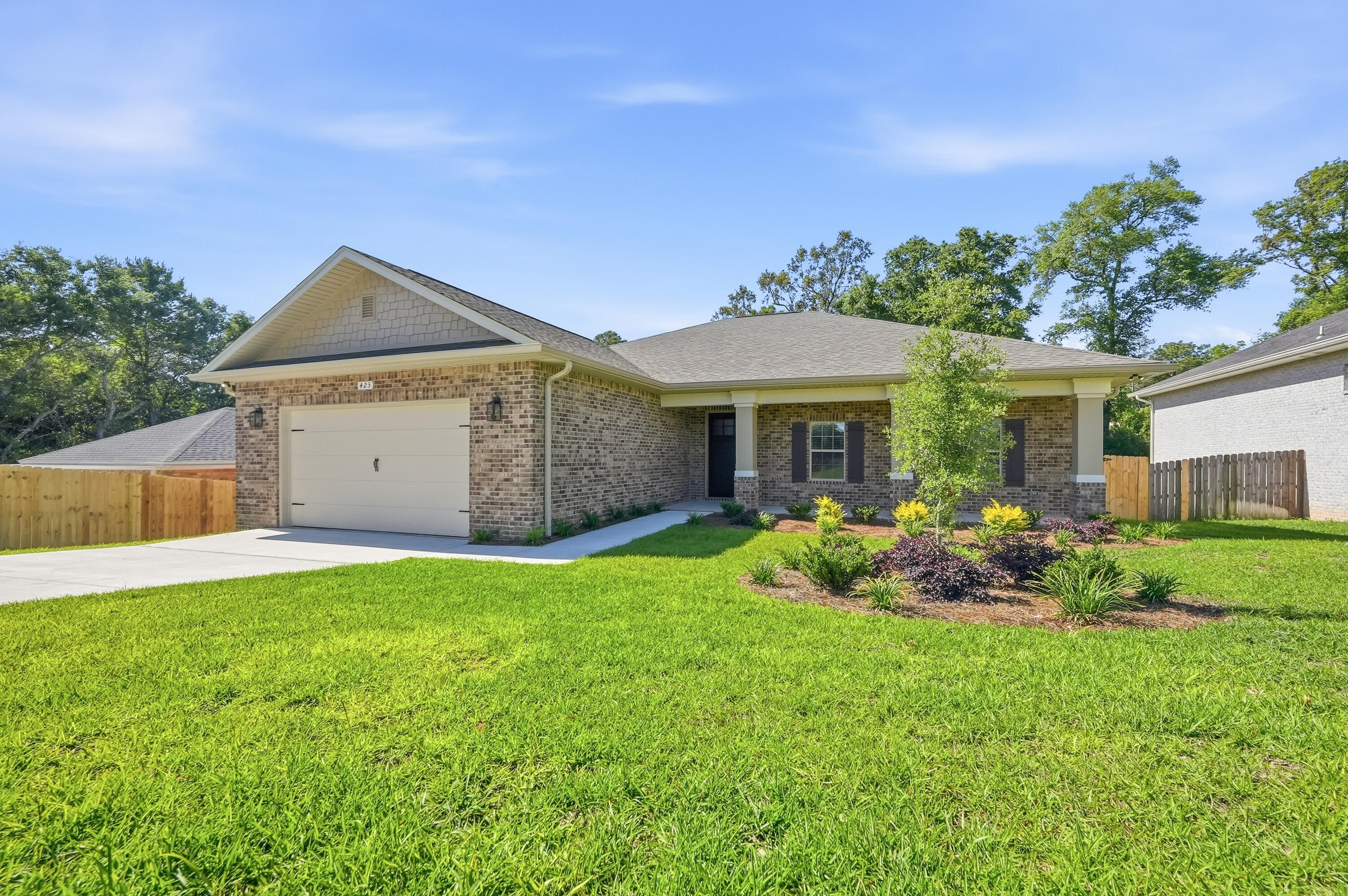 New construction home in Valparaiso near Niceville, Eglin Air Force Base, Duke Field, and 7th Special Forces Group featuring one-story living, a split-bedroom floor plan, oversized fenced backyard, covered outdoor entertaining space, and exceptional storage/workshop area. Conveniently located near shopping, dining, parks, boating, and Northwest Florida beaches.

Designed for both everyday living and entertaining, the open-concept layout offers elevated ceilings, recessed lighting, fireplace, and seamless flow between the living, dining, and kitchen spaces. The kitchen features quartz countertops, stainless steel appliances, gas range, subway tile backsplash, oversized island seating, walk-in pantry, and abundant cabinetry.

The spacious primary suite includes tray ceilings, dual vanities, oversized tile shower, soaking tub, and large walk-in closet. Dedicated office/flex room with French doors provides ideal space for remote work, hobbies, fitness, or guests.

Outdoor living is a standout feature with a large covered back deck overlooking the private fenced backyard with room for entertaining, gardening, pets, or future pool plans. Elevated construction creates additional covered patio space plus enclosed storage/workshop space rarely found in newer construction homes in this area.

Move-in ready and conveniently located near military bases, schools, healthcare, and the Emerald Coast lifestyle buyers are searching for in today's market.