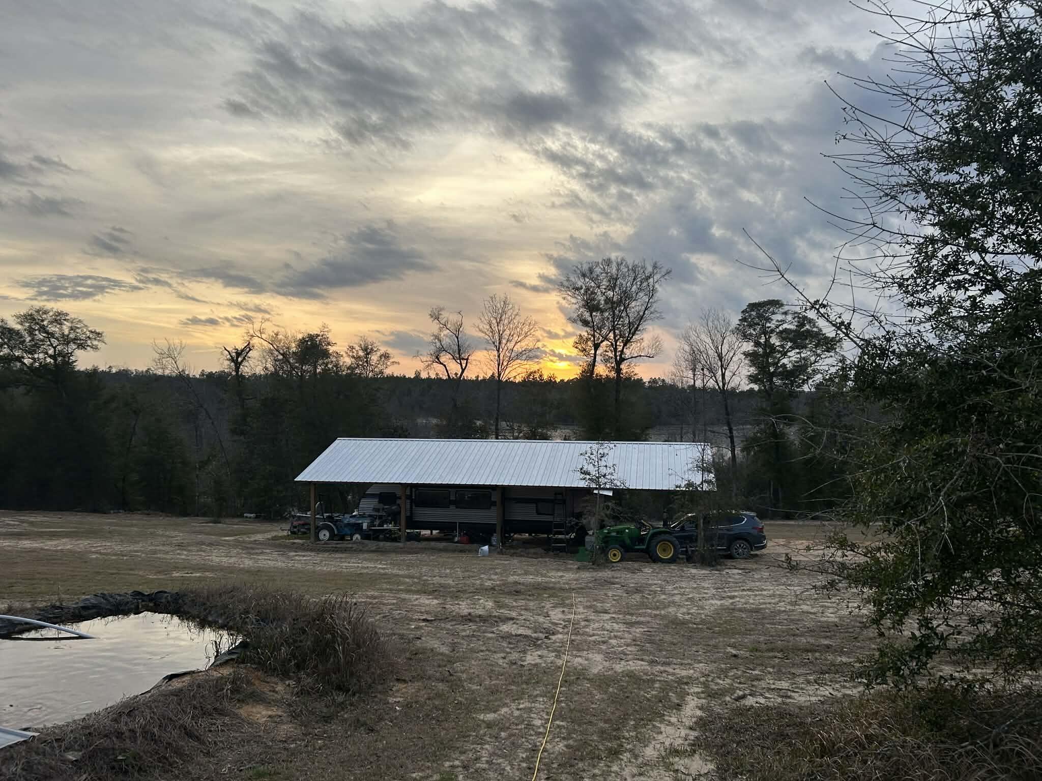 Bring your building plans or mobile home this is an opportunity you don't want to miss! This versatile property is ready for your vision with a pole barn, RV electrical hookups, a 280-ft well, and an existing septic system already in place. Overlooking a beautiful 40-acre spring-fed pond, you'll enjoy peaceful views and abundant wildlife, including deer, turkey, ducks, bass, catfish, and bluegill. Fenced pasture areas make it ideal for cattle or horses. Whether you're dreaming of a private retreat, homestead, or recreational getaway, this property offers endless possibilities.