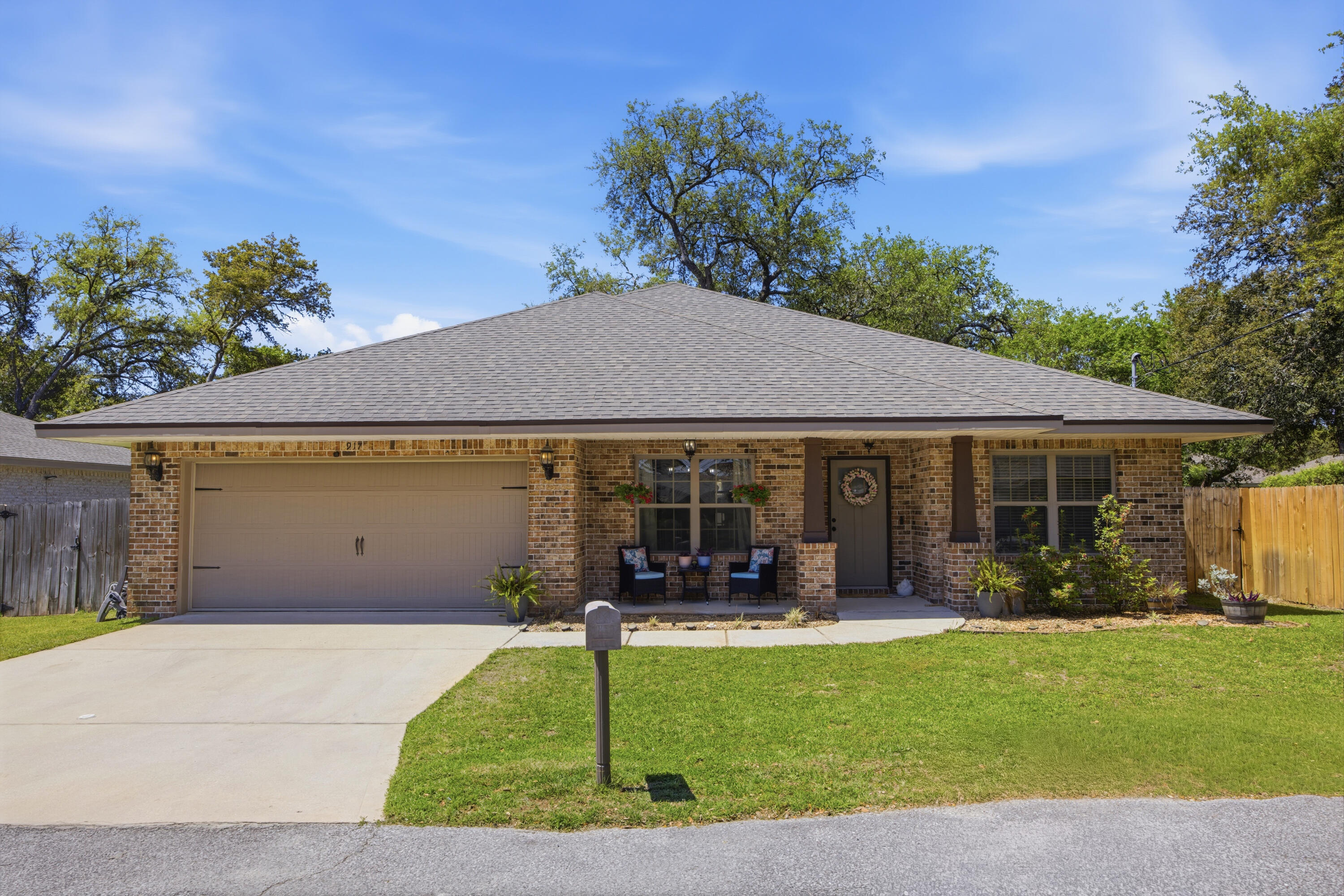 Welcome to this beautifully crafted home in the heart of Mary Esther, ideally located just 2.5 miles west of Hurlburt Field and approximately half a mile from Florosa Elementary School. Built in 2018 by Tracy Acree Construction, this thoughtfully designed residence features a split-bedroom, open-concept floor plan with 10-foot ceilings and abundant natural light throughout. The spacious living area showcases durable LVP flooring, crown molding, and flows seamlessly into the kitchen and dining space, perfect for entertaining or everyday living. The kitchen is a standout, complete with granite countertops, a large breakfast bar, stainless steel appliances, and beautiful maple cabinetry, all complemented by tile flooring for added functionality. Retreat to the private primary suite featuring LVP flooring and a luxurious en-suite bath with his & hers walk in closets, a double vanity, glass-door walk-in shower, and a whirlpool soaking tub. Additional highlights include recessed lighting and ceiling fans throughout, enhancing both comfort and style. Step outside to enjoy the covered lanai overlooking a fully privacy-fenced backyard, ideal for relaxing or hosting gatherings. This home combines modern finishes, thoughtful design, and an unbeatable location; don't miss your opportunity to make it yours!