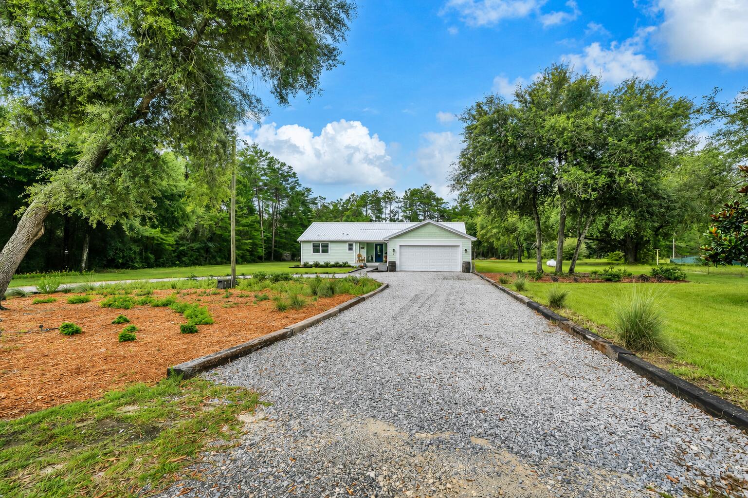 Finding a beautifully renovated home isn't difficult. Finding one that's beautifully renovated on approximately 1.25 acres with room for your RV, a fenced backyard, greenhouse, storage shed, and no HOA is another story. Nearly every finish has been replaced, giving this home the look and feel of new.
Step inside to an open floor plan where luxury vinyl plank flooring flows throughout the home. The inviting living room features a shiplap accent wall with an electric fireplace, while the beautifully redesigned kitchen offers quartz countertops, soft-close cabinetry, stainless steel appliances, designer lighting, and an oversized island that's ready for everything from weeknight dinners to holiday gatherings.
The spacious primary suite is a retreat of its own with a beautifully appointed bathroom featuring dual vanities, custom cabinetry, abundant storage, and an oversized tiled walk-in shower. Every room reflects the care and attention that went into creating a home that's as beautiful as it is comfortable.
The improvements extend well beyond what you can see. Enjoy added peace of mind with a 2024 roof featuring peel-and-stick underlayment, a 2024 water heater, impact-rated exterior doors, an impact-rated garage door, and impact-rated windows throughout the home (with the exception of the garage window).
Outside, approximately 1.25 acres gives you the freedom that's becoming harder to find. Park your RV, enjoy the greenhouse, organize your tools in the storage shed, let pets roam safely in the fenced backyard, or simply relax on the covered back porch and enjoy the quiet. If you've been searching for a home that offers the beauty of a complete renovation and the space to truly live, you've just found it.