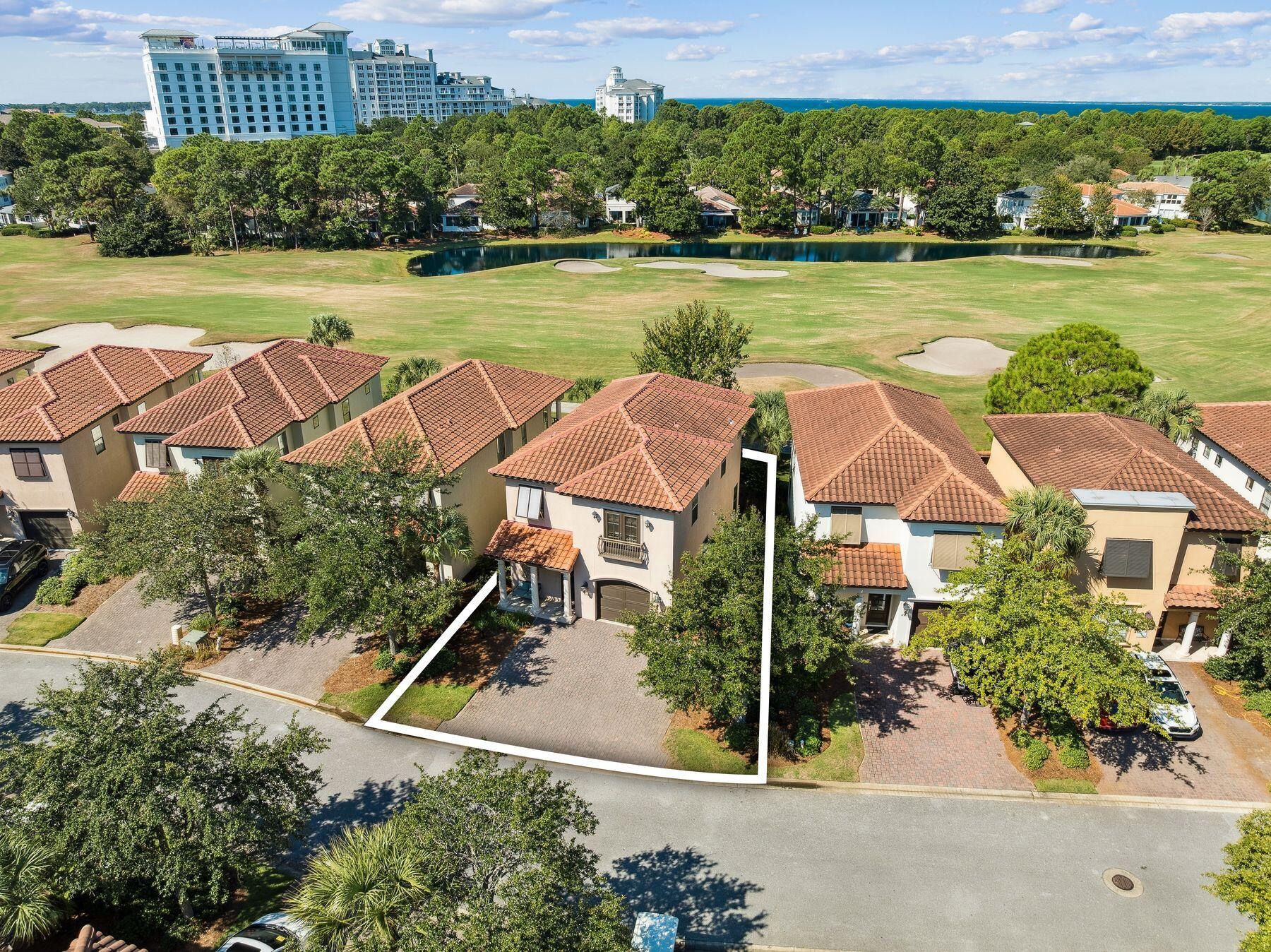 Experience refined coastal living in this beautifully appointed and fully furnished three-bedroom, three-and-a-half-bath home located in the sought-after Villa Lago neighborhood of Sandestin Golf and Beach Resort. Perfectly positioned fronting the Baytowne Golf Course, this professionally decorated two-story residence offers timeless style, comfort, and convenient access to all the amenities of the resort lifestyle. The spacious main level welcomes you with travertine flooring, crown molding, and granite countertops throughout. The gourmet kitchen is equipped with stainless steel KitchenAid appliances, a breakfast bar with seating for four, and a dining area for six, ideal for entertaining. The spacious living area opens to a covered back porch with seating and a propane grill, ideal for relaxing or entertaining. Set along a premium homesite, this porch enjoys tranquil golf course views and a rare sense of privacy with no neighboring porches directly in sight. Additional features include a half bath, owner's closet, an oversized one-car garage with additional room for the included four-seater golf cart and ample space for beach gear, and an expansive driveway with three parking spaces. Upstairs, each of the three bedrooms offers a private ensuite bath for optimal comfort and privacy. The primary suite features a king bed, dual vanities, an oversized soaking tub, deep walk-in shower, and a private balcony overlooking the fairway. The guest suite includes a queen bed and floor to ceiling windows, while the third bedroom provides two twin beds perfect for family or guests. A laundry room and additional walk-in owner's closet complete the upper level. Nestled between serene water features and the Baytowne Golf Course, Villa Lago residents enjoy access to community pools, tennis and pickleball courts, multiple golf courses, and all the exclusive Sandestin Resort amenities. Conveniently located within walking distance of The Village of Baytowne Wharf and just a short bike or trolley ride to the white-sand beaches of the Emerald Coast, this home offers the perfect combination of relaxation, recreation, and resort-style living. Ideal as a primary residence, vacation retreat, or rental investment, this Villa Lago property captures the best of the Sandestin lifestyle where everyday living feels like a getaway.