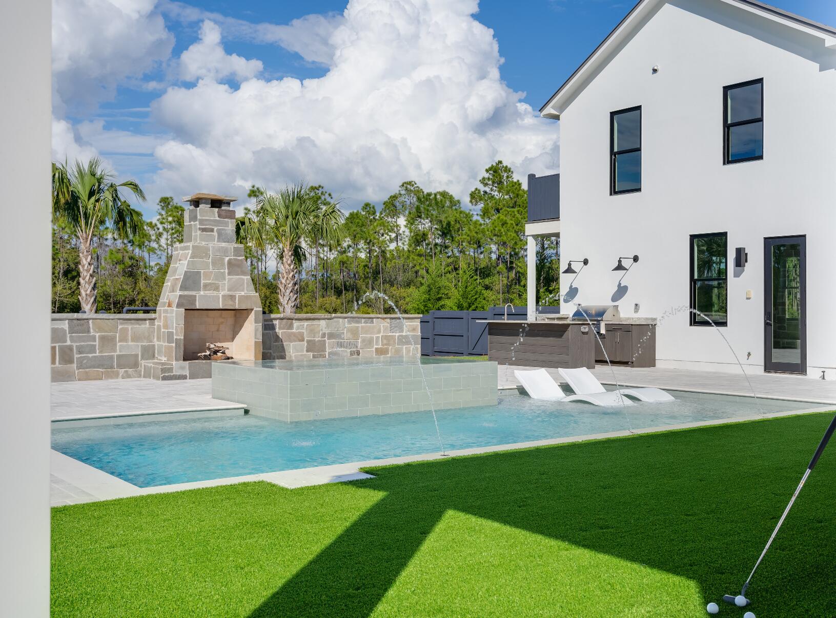 Experience refined coastal living at its finest in this extraordinary 2024-built residence, located in the highly coveted and gated Watersound Camp Creek community—home to the exclusive Beach Club and Camp Creek Golf Course. Spanning 5,334 square feet, this architectural gem offers 5 bedrooms, 6.5 baths, and a seamless integration of indoor and outdoor living, ideal for those seeking a full-time sanctuary by the sea. From the moment you step inside, you'll be captivated by soaring 10-foot ceilings, warm European oak flooring, and an open layout that invites effortless flow and entertaining. A spacious fireside great room anchors the main level, opening into a gourmet kitchen outfitted with a striking marble waterfall island, bespoke lighting, European-style cabinetry, and high-end Dacor graphite stainless appliances. A walk-in pantry and prep space enhance its culinary appeal, while a separate dining room, complete with wet bar, wine fridge, and ice maker, makes entertaining a breeze.
The main floor also features one of two stunning primary suites with a spa-inspired bathroom, a soaking tub, and a walk-in closet the size of a bedroomperfect for custom design. You'll also find a dedicated office/library, full pool bath, powder room, generous laundry/mudroom, and additional storage. Upstairs, luxury continues with a second lavish primary suite, a bonus/media room that could convert to a sixth bedroom, built-in dual desk area, and a secondary flex roomideal as a fitness space or second office. Two additional en-suite bedrooms with large walk-in closets provide comfort and privacy for guests or family.
Set on nearly half an acre in a quiet cul-de-sac, the backyard is a private resort of its ownfeaturing a heated saltwater pool with sun shelf, infinity-edge hot tub, outdoor fireplace, summer kitchen, and a 500 sq. ft. covered loggia. The fenced yard offers abundant green space for play or pets. Parking is effortless with a two-car garage (epoxy floors & EV charger), a separate golf cart garage, and a two-car porte-cochère.
Completing this exceptional offering is a detached carriage house with its own private entry, vaulted ceilings, kitchenette, walk-in closet, and full bathideal for guests, in-laws, or a creative studio. This is more than a homeit's a lifestyle. Welcome to 83 Norman Court, where craftsmanship, privacy, and elegance converge in one of the most exclusive enclaves along 30A. Schedule your private tour today.