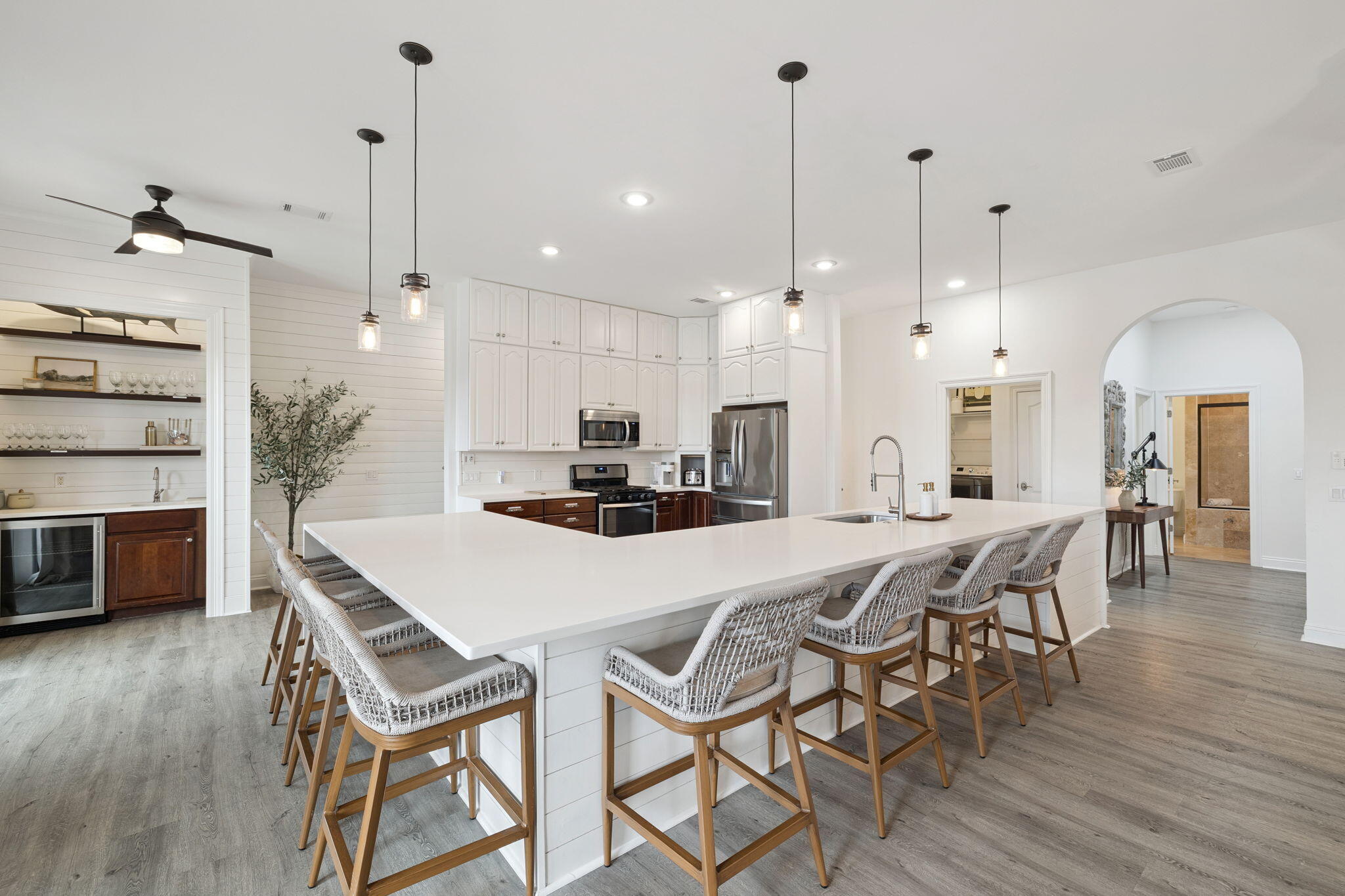 A stunning lakefront estate in the heart of Destin, Florida, this eight-bedroom, six-bathroom retreat offers a rare combination of privacy, elegance, and walkable beach access. Located within a secure gated community and just minutes from the Gulf, this residence embodies coastal luxury at every turn.

Spanning three thoughtfully designed levels, the home offers exceptional comfort and functionality. Recently updated with fresh paint, furnishings, and decor. On the first floor, a two-car garage provides ample storage, while a spacious recreation and workout room with a full bathroom including a stand-up shower creates the perfect space for active living. A large bunk room comfortably sleeps 6 to 8 guests, making it ideal for hosting extended family or vacation renters. The second floor serves as the main gathering level, where two generous bedrooms each with large walk-in closets complement the expansive living area. The open-concept kitchen is fully appointed with quartz countertops, upgraded appliances, and picturesque views of the lake. An oversized kitchen island with seating for eight offers a central hub for entertaining and casual dining. The spacious living room features ample seating, a built-in entertainment center, and access to one of the home's multiple outdoor decks. Two full bathrooms and a fully equipped laundry room complete this level.

Upstairs, the third floor boasts four large fully furnished bedrooms and access to a private balcony and covered porch. The bathrooms are designed with quartz countertops, glass-enclosed showers, and double vanities for a spa-like feel. A Jack and Jill bathroom connects two of the guest bedrooms, both of which are appointed with queen beds and flat-screen TVs.

Fully furnished and turnkey, the home is rental ready with a projected income of over $213,000 annually, offering an exceptional opportunity for investors or those seeking a second home along Florida's Emerald Coast.

With deeded access to the private beach just a short walk away and resort-style amenities including a community pool, this property offers an unmatched blend of serenity, style, and convenience. Moments from Destin's premier shopping, dining, and recreation, it delivers the ultimate expression of luxury coastal living