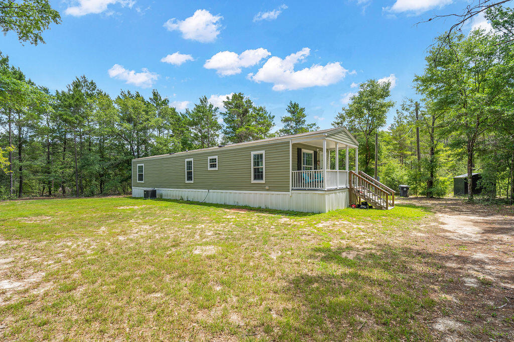 Tucked away on a spacious wooded lot in Oakwood Hills, this beautifully maintained 2022 mobile home offers the perfect blend of privacy, comfort, and affordability. Featuring 2 bedrooms, 2 bathrooms, and an open-concept living and kitchen area, this home feels bright, welcoming, and move-in ready. Enjoy peaceful mornings or relaxing evenings on the covered front porch surrounded by nature. Situated on approximately 0.71 acres with plenty of room to spread out, this property provides the quiet country setting buyers are looking for while still offering convenient access to DeFuniak Springs, Crestview, I-10, and the Emerald Coast beaches. Whether you're searching for a primary residence, weekend getaway, or investment opportunity, this property is a must-see!