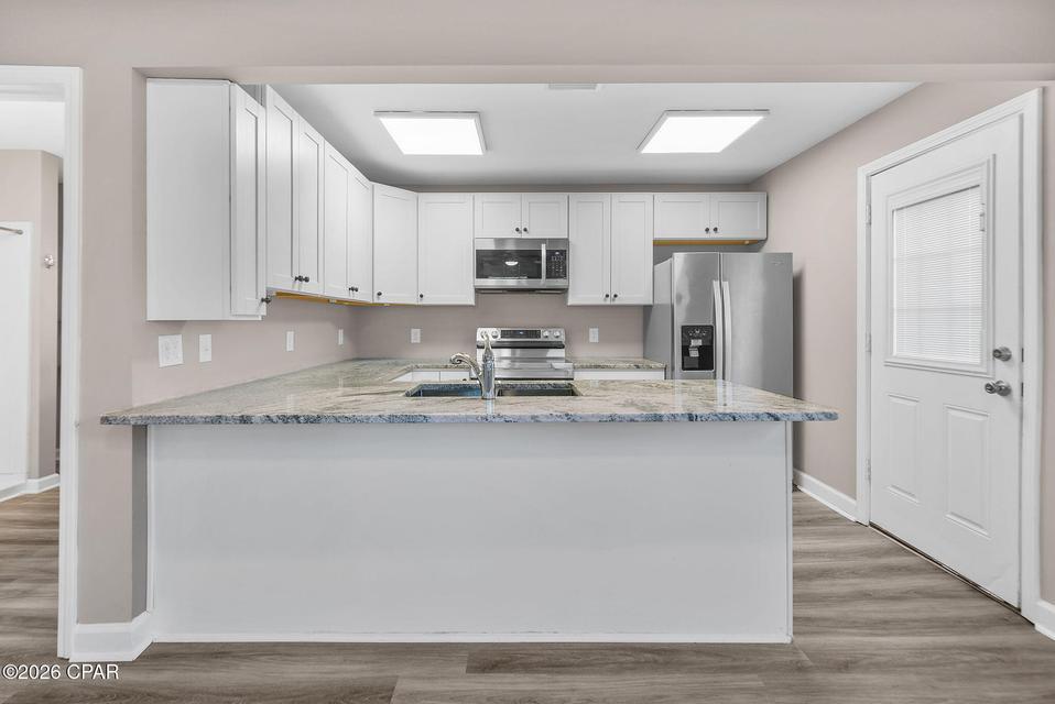 Price Reduced! Positioned in a prime central location near both historic St. Andrews and downtown Panama City, this updated home offers a bright and open interior designed to maximize every inch of living space. The home features surprisingly large room proportions in the open concept kitchen and living room and in the bedroom complete with a walk-in closet.  This creates a comfortable atmosphere that lives much larger than its footprint. 

Comprehensive recent upgrades enhance the property, including new vinyl plank flooring, fresh paint, energy-efficient windows, window treatments, and stylish updated light fixtures and ceiling fans. The modern kitchen serves as a functional centerpiece, equipped with granite countertops, a breakfast bar, stainless steel appliances, and premium soft-close cabinetry.  The home's layout is complemented by practical luxuries such as a spacious walk-in closet, linen storage area in the bathroom, and a tankless water heater for on-demand efficiency. Ready for immediate move-in, the residence also includes a recently serviced HVAC system and a modern front-load washer and dryer. 

Outside, the property provides a sense of seclusion on an oversized 50' x 90' lot, which is fully enclosed by a privacy fence. The addition of an extra-large gate across the driveway allows for a completely private perimeter for both the front and rear of the home.  This home has no HOA fees to worry about and offers the option of both long-term and short-term rental opportunities.  The property is conveniently situated near popular local dining and retail areas and is just one mile from Gulf Coast Hospital or Publix. With easy access to Tyndall Air Force Base, as well as only about a fifteen-minute drive to the white sandy beaches of Panama City Beach, this home offers an exceptional blend of modern quality and convenience.