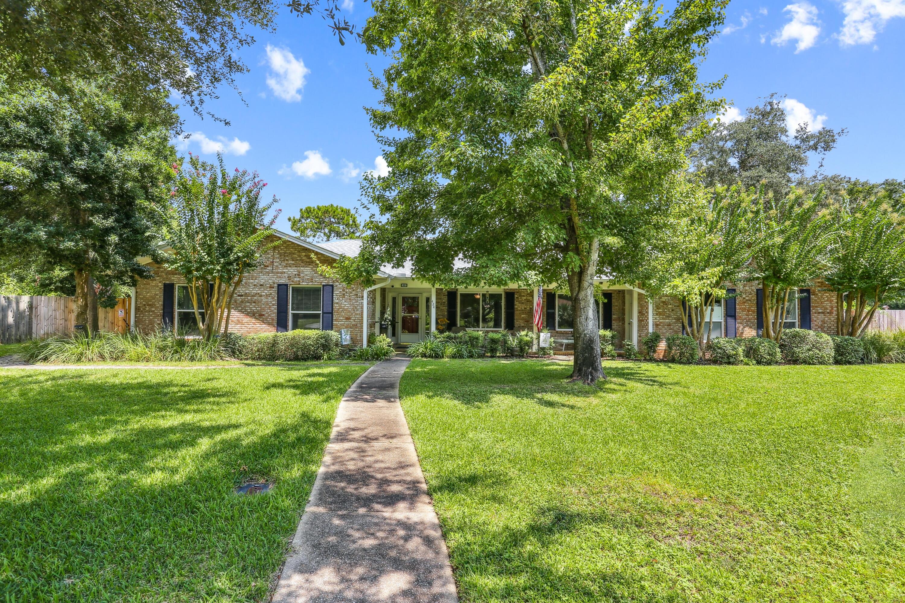 Schools Out For Summer!! Time to make your move...Drop by before you hit the beach Saturday June 20th from 12:00 - 3:00 PM ** Unbeatable location in Gulf Breeze Proper! This golf cart-friendly community features an A-rated school system, Shoreline Park with boat launch and pier, the Gulf Breeze Rec Center offering activities for all ages--tennis, pickleball, yoga, and more--plus a neighborhood library, fire station, and police department. Just minutes to Pensacola Beach and Downtown Pensacola!This move-in ready, all-brick home features an updated kitchen, renovated bathrooms with designer tile finishes, and gorgeous tile flooring throughout--NO carpet. Enjoy outdoor living with a huge 18x18 screened porch overlooking your private pool. The versatile layout supports multi-generational living or rental income potential. There are 3 bedrooms and 2 full baths on one side and an attached self contained 1 bedroom apartment on the other complete with kitchenette, full bath and separate entrance. Completely fenced backyard, and an irrigation system with well too!  Major updates include impact-resistant windows & 2021 roof with clips (lowering insurance costs), new water heater (2025), replaced ductwork with added UV light system, new sprinkler pump (2025), new pool liner (2025). Located in flood zone "X". Don't miss this rare opportunity to enjoy the unmatched lifestyle of Gulf Breeze Proper--where convenience, community, and coastal living come together!