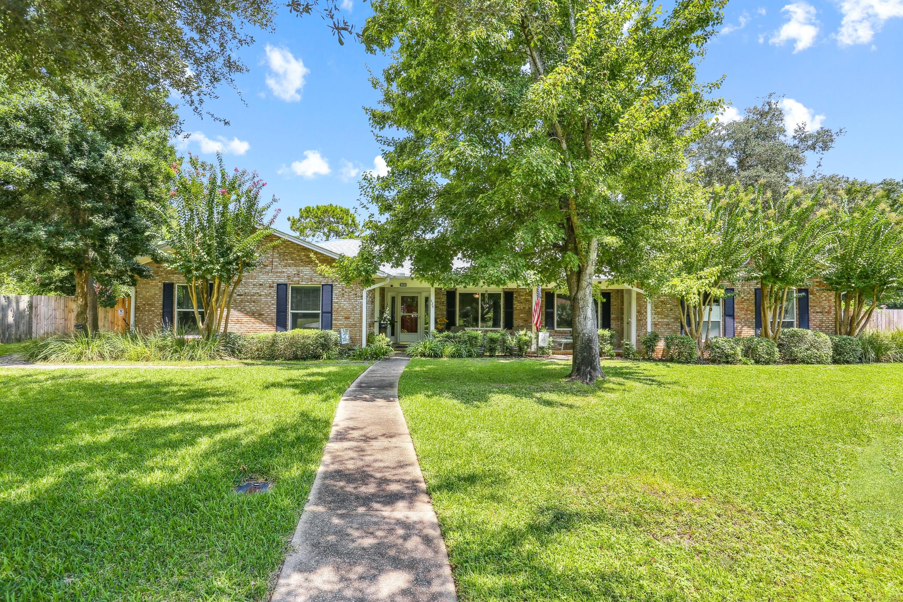 Rare income-producing or multi-generational layout in the absolute heart of Gulf Breeze Proper! This move-in ready, all-brick ranch features a highly versatile design offering a primary 3-bedroom, 2-bathroom residence on one side, and a fully self-contained attached 1-bedroom, 1-bathroom apartment on the other, complete with its own kitchenette, full bath and private entrance. Perfect as a high-yield rental space, guest house or independent in-law suite. The interior boasts gorgeous low-maintenance tile flooring throughout (zero carpet), an updated kitchen that seamlessly opens to a spacious living room centered by a cozy fireplace, and elegantly renovated bathrooms featuring custom designer tile finishes. Step outside to a private, beautifully landscaped outdoor oasis featuring a massive 18 x 18 screened porch overlooking your private in-ground pool. Massive structural & insurance-saving upgrades include: * Fortified Exterior: Impact-resistant windows and a 2021 shingle roof with hurricane clips, driving down insurance premiums. * No Flood Insurance required: located in Flood Zone X. * 2025 Major Mechanics: Brand new pool liner, new high-efficiency water heater, and a new sprinkler pump for the dedicated irrigation well (free lawn watering!) * Air Quality: Fully replaced ductwork integrated with an advanced UV light purification system. Situated in an unbeatable golf cart-friendly neighborhood with an A-rated school system! You are just steps away from Shoreline Park's boat fishing pier, and Gulf Breeze Rec Center, and only minutes from Pensacola Beach. Enjoy the ultimate blend of coastal convenience, community, and built-in equity!