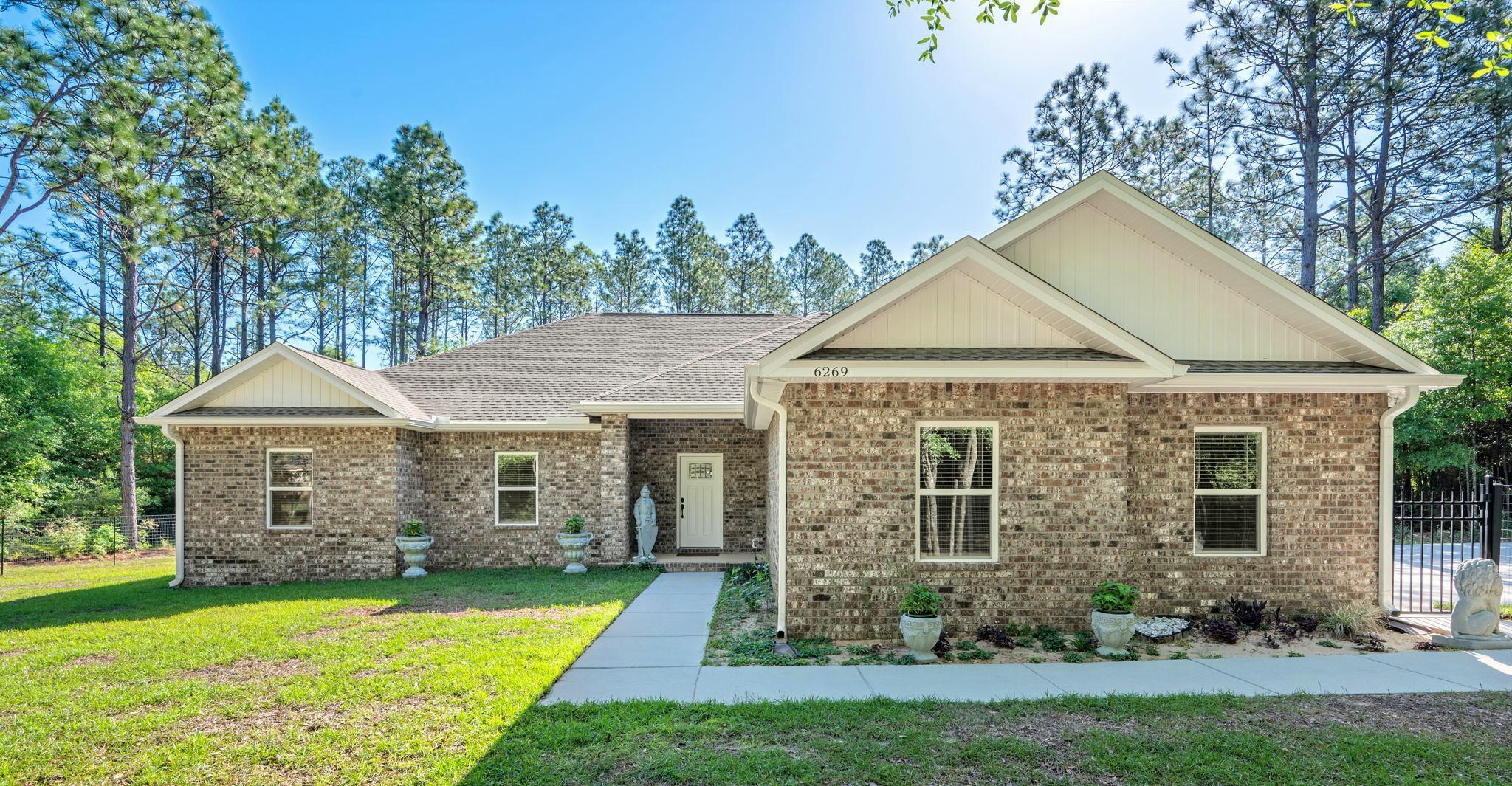 Impeccable 3-year-old semi-custom home on one acre square lot surrounded by majestic trees. County taxes only, no HOA and no restrictions, bring your animals. Secluded park-like setting, large parking area for RV or boat.  Fully fenced in yard. Open concept split floor plan with huge living area and electric fire place. Expansive spa-like master bath with barn door, tile flooring and huge glass shower. 9-foot ceilings throughout. The kitchen features modern lighting, shaker cabinets and quartz countertops with glass back splash. Walk-in closets and oversized garage. Massive back porch. Energy efficient with low utilities. Easy access to Eglin AFB, Duke Field,  Hulburt Field and beaches. Close to shopping, and parks. Modern upgrades and an exceptional lot make this home a rare opportunity.