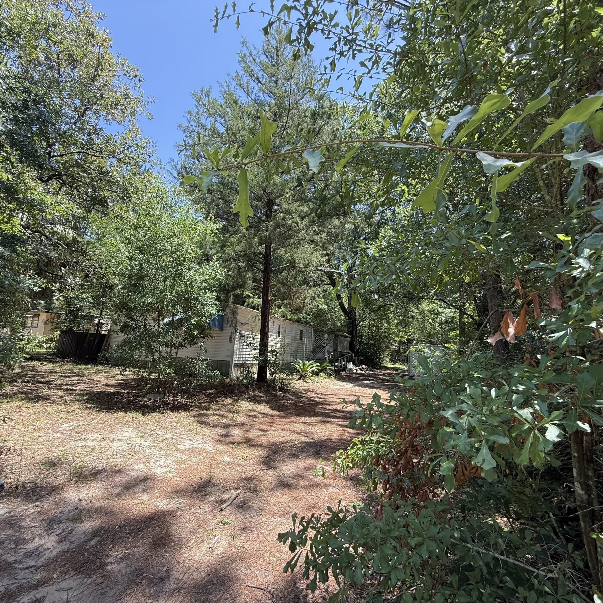 Huge lot with a 1981 2-bedroom 1 bathroom 840 sq ft mobile home given no value however could be possibly repaired via the right person. There is also a 2nd mobile home in the back given no value. There are two septic tanks and two meters on the property. Seller is motivated.