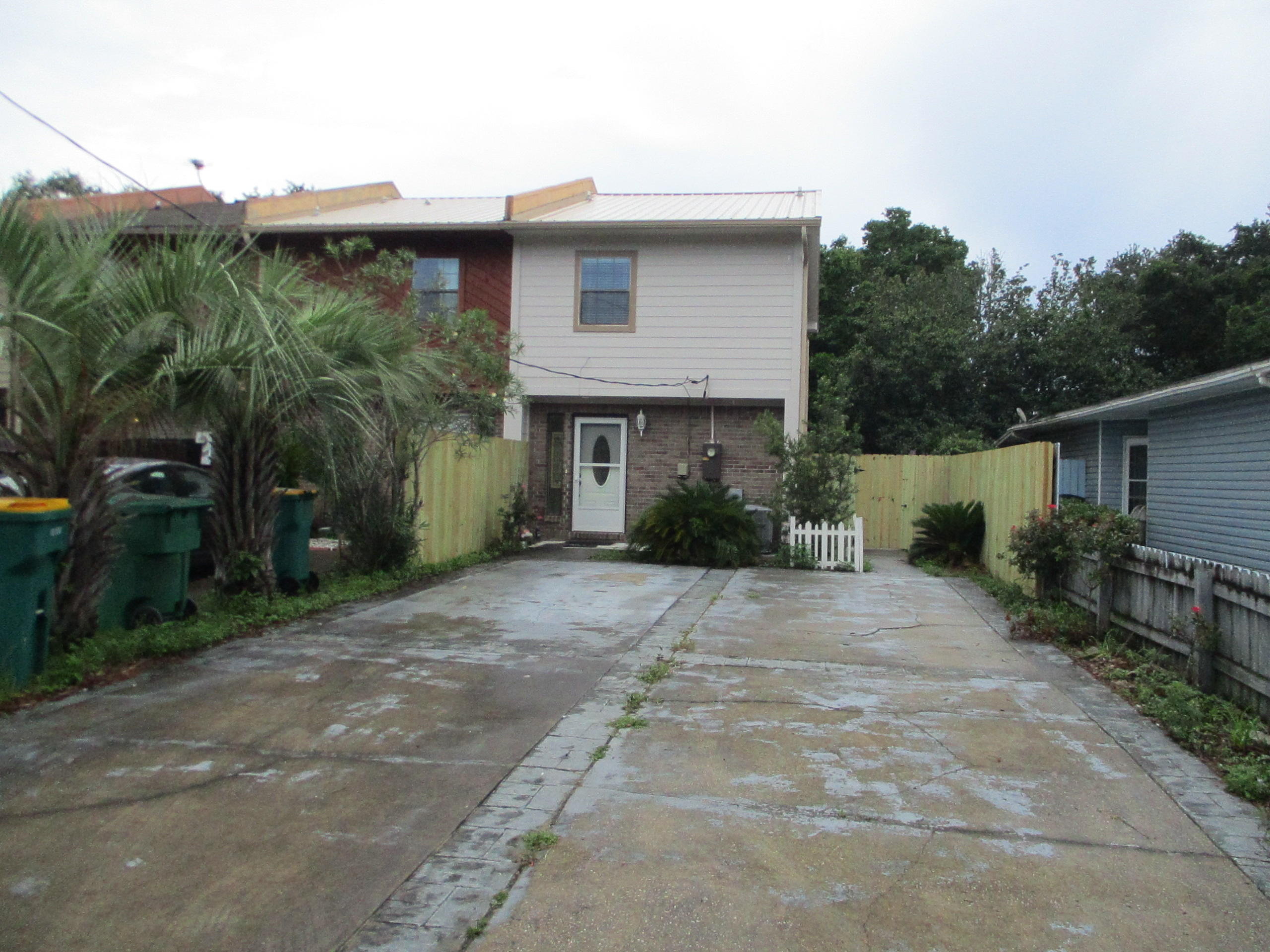 Spacious End Unit Townhome. Roomy Living/Dining Room Combo that opens up to a covered patio, which is fully fenced. Kitchen is large with plenty of cabinets and counterspace. There is an indoor laundry room off the kitchen. ( note: washer and dryer not incl) The master bedroom features a walk in closet and private balcony. Large driveway with extra parking. No Carpet- Wood flooring everywhere except the kitchen and baths which are tiled.  Newer paver patio in back yard. Call to see the townhome today.
