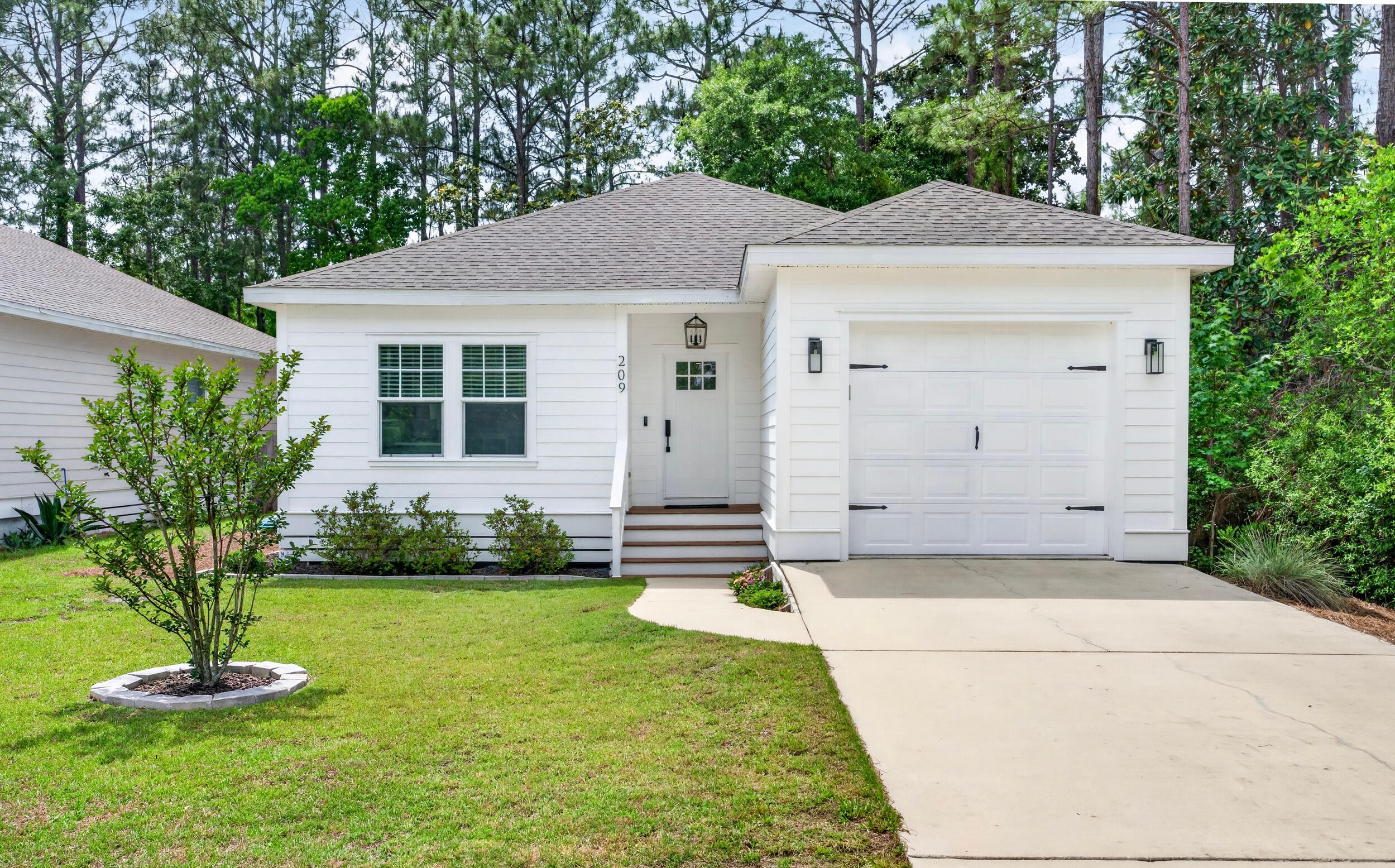 Bright, airy, and thoughtfully designed, this newer construction coastal-inspired 3BR/2BA home in Santa Rosa Beach offers an inviting open layout with timeless finishes throughout. Shiplap accents, nine-foot ceilings, and luxury vinyl plank flooring create a light and relaxed feel, while the custom floor-to-ceiling built-in bookcase with electric fireplace adds warmth and character to the living space. The kitchen features quartz countertops, marble backsplash, oversized island, vent hood, and custom cabinetry extended to the ceiling. Additional highlights include a one-car garage, new exterior paint (2024), and no HOA or rental restrictions, offering added flexibility for full-time living, a second home, or investment potential. Conveniently located near Cessna Landing and just 10 minutes from 30A and Ed Walline Beach Access.