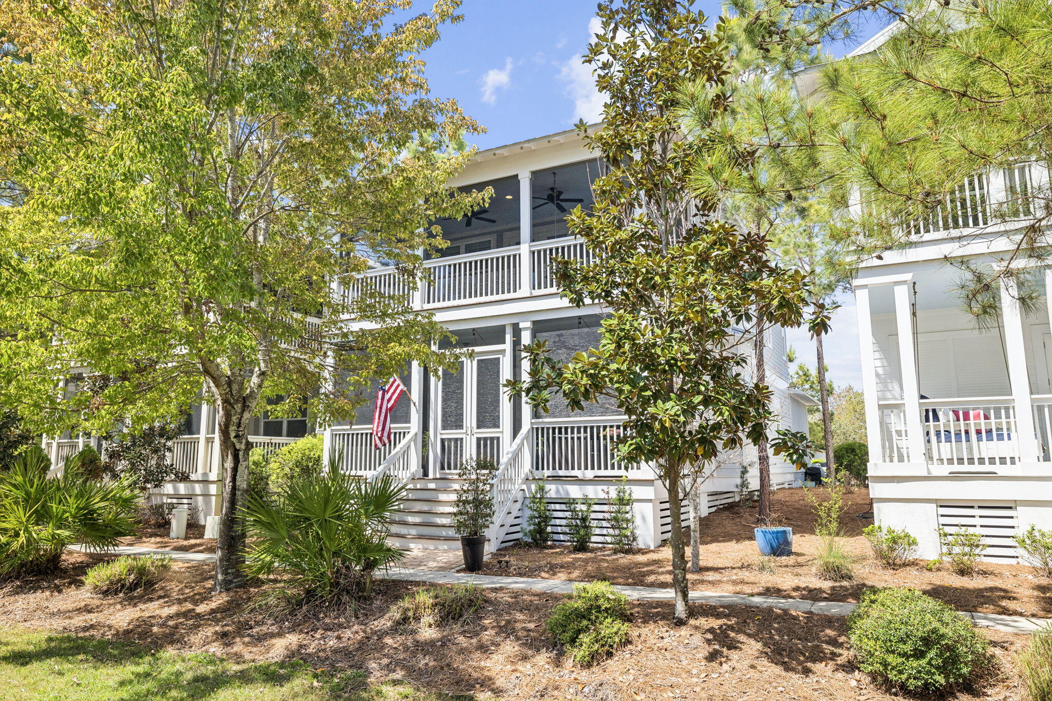 Welcome to this beautifully maintained 4-bedroom, 3.5-bath, 2 car garage, coastal retreat in the highly desirable NatureWalk at Seagrove community, just off 30A. Never rented and meticulously cared for, this airy and light-filled home features fine wide plank French oak hardwood flooring, timeless coastal finishes, and an inviting open-concept layout designed for effortless entertaining. The flexible floor plan includes two primary suites, one conveniently located on the main level and another upstairs, making it ideal for hosting guests or accommodating multi-generational living. The second floor also features a spacious bonus living area perfect for a media room, game space, or additional lounge. Throughout the home, you'll find an abundance of storage, a rare and highly valuable feature that enhances everyday functionality. The home offers two expansive porches with Bermuda shutters for added privacy, perfect for enjoying peaceful mornings or unwinding after a day at the beach. NatureWalk at Seagrove offers resort-style amenities including three pools, pickleball and basketball courts, a playground, and scenic nature trails woven throughout the community. Owners also enjoy access to the Lily Lane Beach Trail, leading directly to San Juan Avenue and nearby public beach access, offering a convenient connection to the Gulf. Whether you're searching for a full-time residence, second home, or investment property, this exceptional home delivers the perfect combination of location, comfort, and coastal charm.