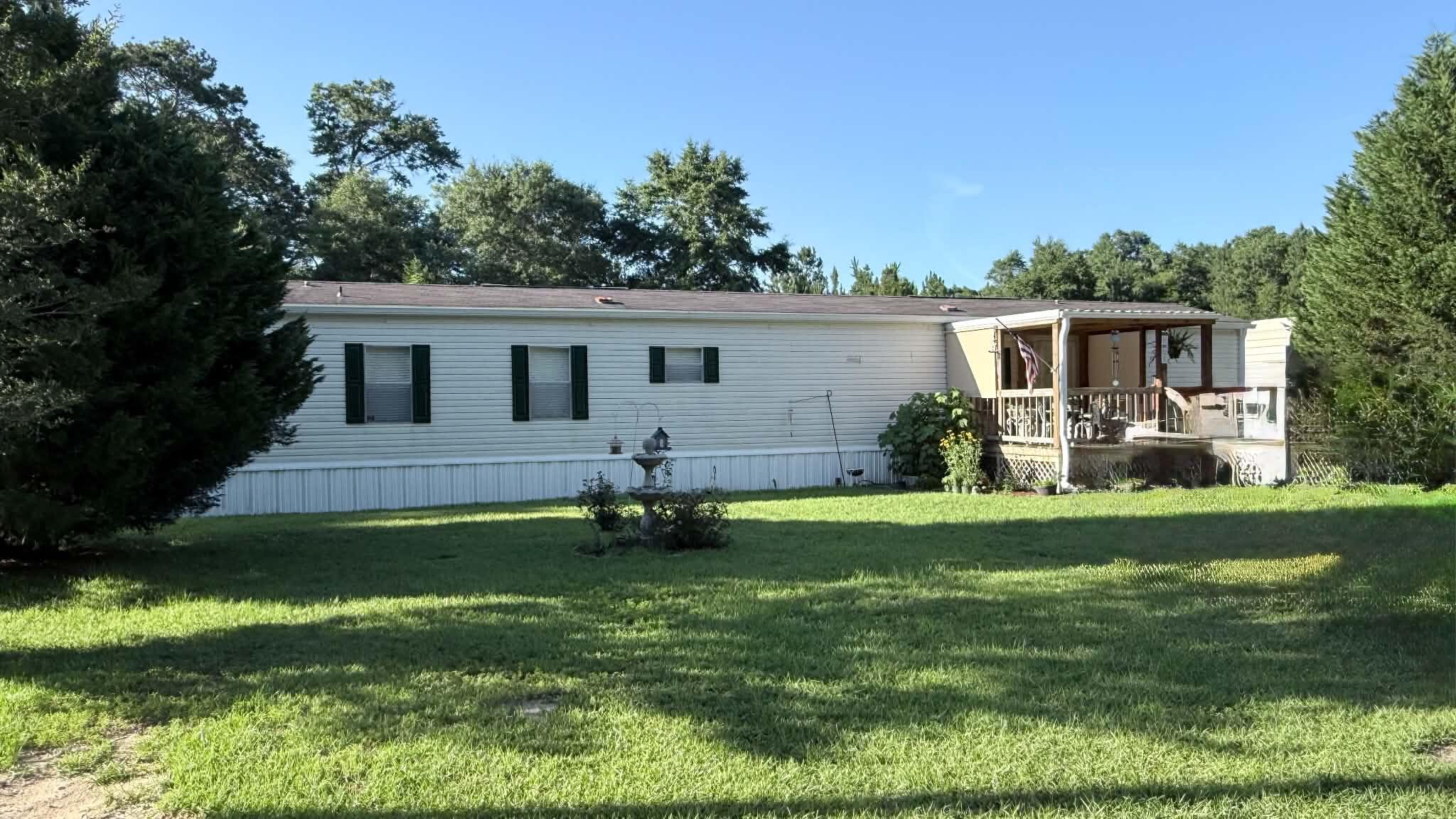 Single wide manufactured home in the Paxton City limits and Paxton School District - Paxton is an ''A'' school for all grade levels. Bedrooms are at each end of the home. Spacious master bedroom. Master bath features garden tub and double vanity. Unbelievable master closet, Eat-in kitchen with breakfast bar. Laundry area in hallway. Large front deck. Purchase includes 2 additional lots. Privacy fenced yard on 2 sides.  Just a short distance to Lake Jackson and all of the recreational opportunities there.