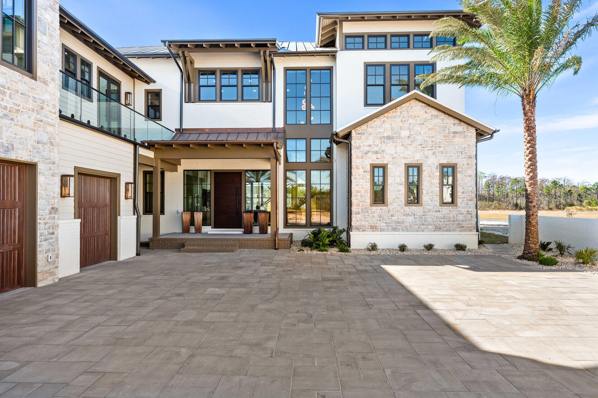 Recently completed and fully move-in ready, 75 N Southern Cross Lane offers a rare opportunity to own a 2025 Parade of Homes Winner in the prestigious gated community of WaterSound Camp Creek. Now strategically repositioned at $5,399,000, this nearly 7,000-square-foot estate blends exceptional craftsmanship, resort-style amenities, and timeless coastal design in one of the most exclusive settings along 30A. Designed for both everyday comfort and elevated entertaining, the residence features dual primary suites, soaring beamed ceilings, expansive living spaces, and a seamless balance of luxury and functionality. Every detail has been thoughtfully executed, delivering the advantages of brand-new construction without the delays of building. Inside, the home was designed to elevate both daily living and large-scale entertaining. A chef's kitchen is paired with a discreet secondary service kitchen, while two laundry rooms, an in-home elevator, and a 2.5-car garage add convenience throughout. Dedicated spaces include an executive office, fully equipped fitness room, state-of-the-art theater, and expansive game room with wet bar. The private wellness suite creates a true spa-like experience with a steam room, dry sauna, cold plunge, and dedicated shower.

Outdoors, the property transforms into a private resort-style retreat centered around a stunning pool, spa, and outdoor kitchen overlooking a peaceful pond. The detached carriage house above the garage offers guests complete privacy with its own entrance and full kitchen. Natural stone accents, a grand auto court, and striking coastal architecture further enhance the home's commanding curb appeal.

Ownership within WaterSound Camp Creek provides access to an unmatched lifestyle, including eligibility for exclusive WaterSound Club membership opportunities. Residents enjoy private beach access with chair and towel service, championship golf, resort-style pools with a lazy river, premier fitness and wellness facilities, tennis and pickleball courts, and exceptional dining and spa experiences at Camp Creek Inn, The Pearl, and WaterColor Inn.

With only 263 homesites, WaterSound Camp Creek remains one of the most sought-after luxury communities on the Gulf Coast. 75 N Southern Cross Lane represents a rare chance to secure a newly completed legacy property offering immediate enjoyment, extraordinary amenities, and a level of lifestyle value rarely found along 30A.