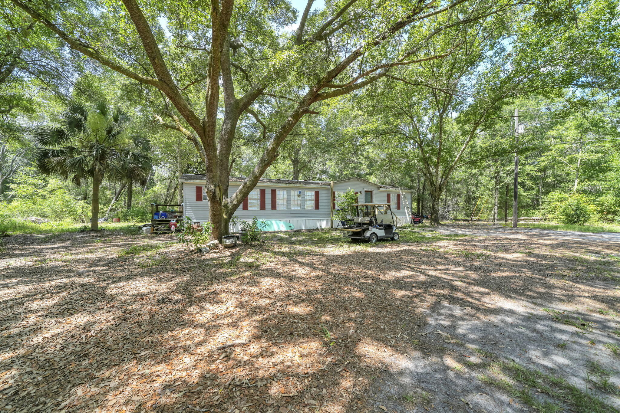 Build your dream home on this beautiful 4+ acre homesite at 41 Frogs Road, offering the perfect combination of privacy, convenience, and natural beauty. Nestled among mature native trees with a blend of wooded and cleared areas, this Estate Residential property provides an exceptional setting for a custom home, private estate, or generational family homestead.

Located just minutes from Freeport's growing shopping, dining, schools, and town center, you'll enjoy the tranquility of country living while remaining close to everyday conveniences and the Emerald Coast's renowned beaches, boating, and outdoor recreation.

The property is improved with city water, an existing septic system, and an older mobile home that is given little to no contributory value and is being conveyed as-is, allowing the focus to remain on the value of the land, existing utilities, and outstanding homesite. Existing improvements provide an excellent foundation for your future plans.

Situated in FEMA Flood Zone X (minimal flood risk), this property offers added peace of mind for many buyers. With ample space for a custom residence, detached garage or workshop, gardens, recreational vehicles, and outdoor living, the possibilities are endless. Buyers should verify all intended uses with Walton County.

Opportunities to own more than four acres with existing utilities, exceptional privacy, and a prime Freeport location are increasingly rare. Come experience the potential of the lifestyle that awaits!