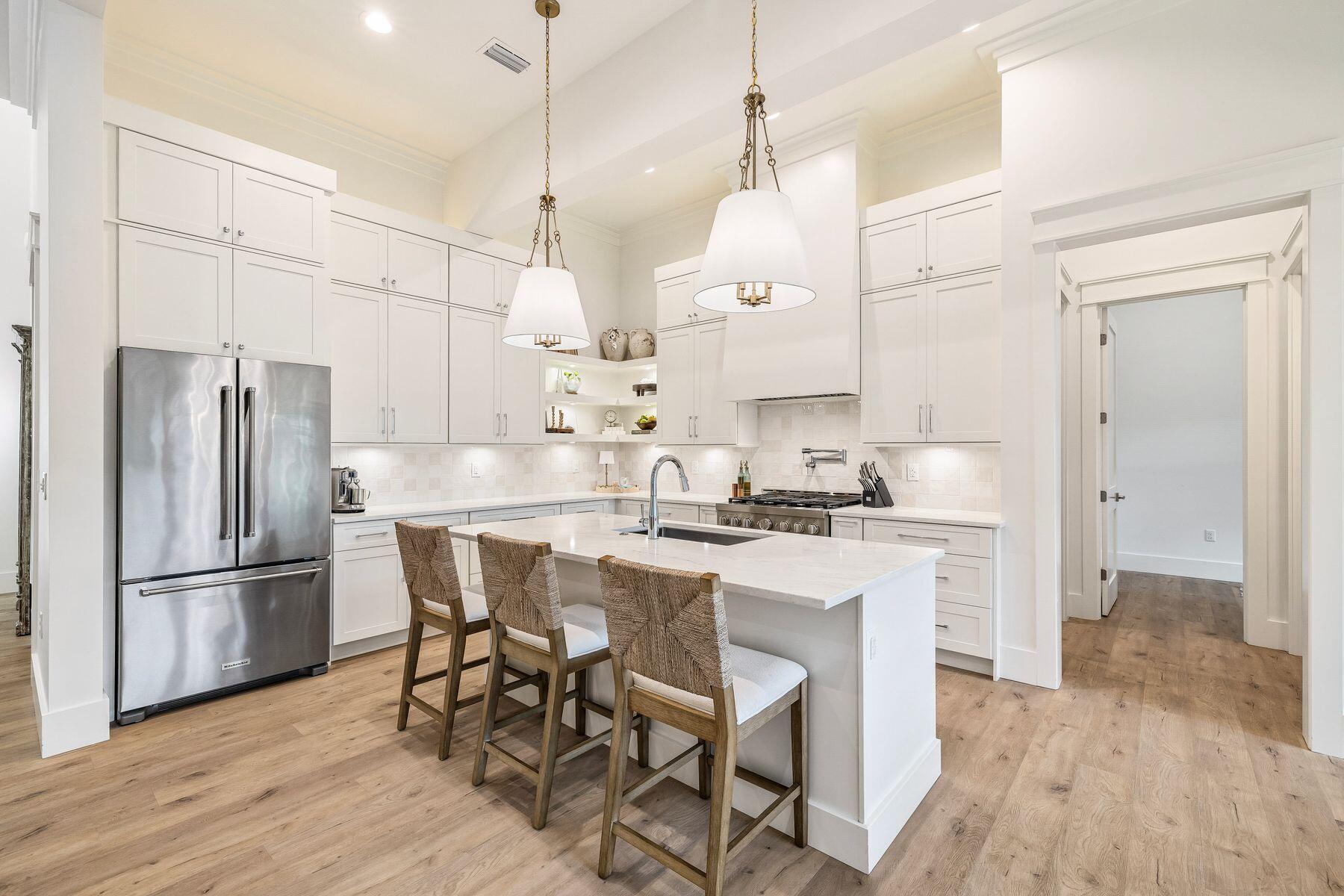 Nestled on a quiet dead-end street and bordered by protected land to the east, this thoughtfully designed custom home offers the perfect blend of luxury, comfort, and functionality. Built in 2024 by Matt Lollie, the home features soaring 12-foot ceilings and an open, airy main floor designed for effortless gathering and entertaining.

Currently enjoyed as a primary residence, the property also offers strong investment potential. A previously approved site plan included the option for a 20' x 12' pool, providing future owners with added flexibility and opportunity.

At the heart of the home, a commercial-style KitchenAid range anchors the chef's kitchen, complemented by an oversized walk-in pantry and generous gathering spaces. The living area flows seamlessly onto a spacious screened porch, creating the perfect setting to enjoy the coastal lifestyle year-round.

Designed with both functionality and privacy in mind, the first floor features a well-appointed primary suite and guest bedroom positioned on opposite sides of the home. Upstairs, two additional bedrooms provide comfortable accommodations for family and guests.

Ideally located within walking distance of public beach access, this home also offers easy access to some of the area's favorite restaurants, shops, and entertainment. Enjoy a quick bike ride or golf cart ride to Shunk Gulley, Goatfeathers, and nearby conveniences while still enjoying the privacy of a quiet, tucked-away setting. Combining quality construction, thoughtful design, and an exceptional location, this is a rare opportunity to own a custom-built home just moments from the Gulf.