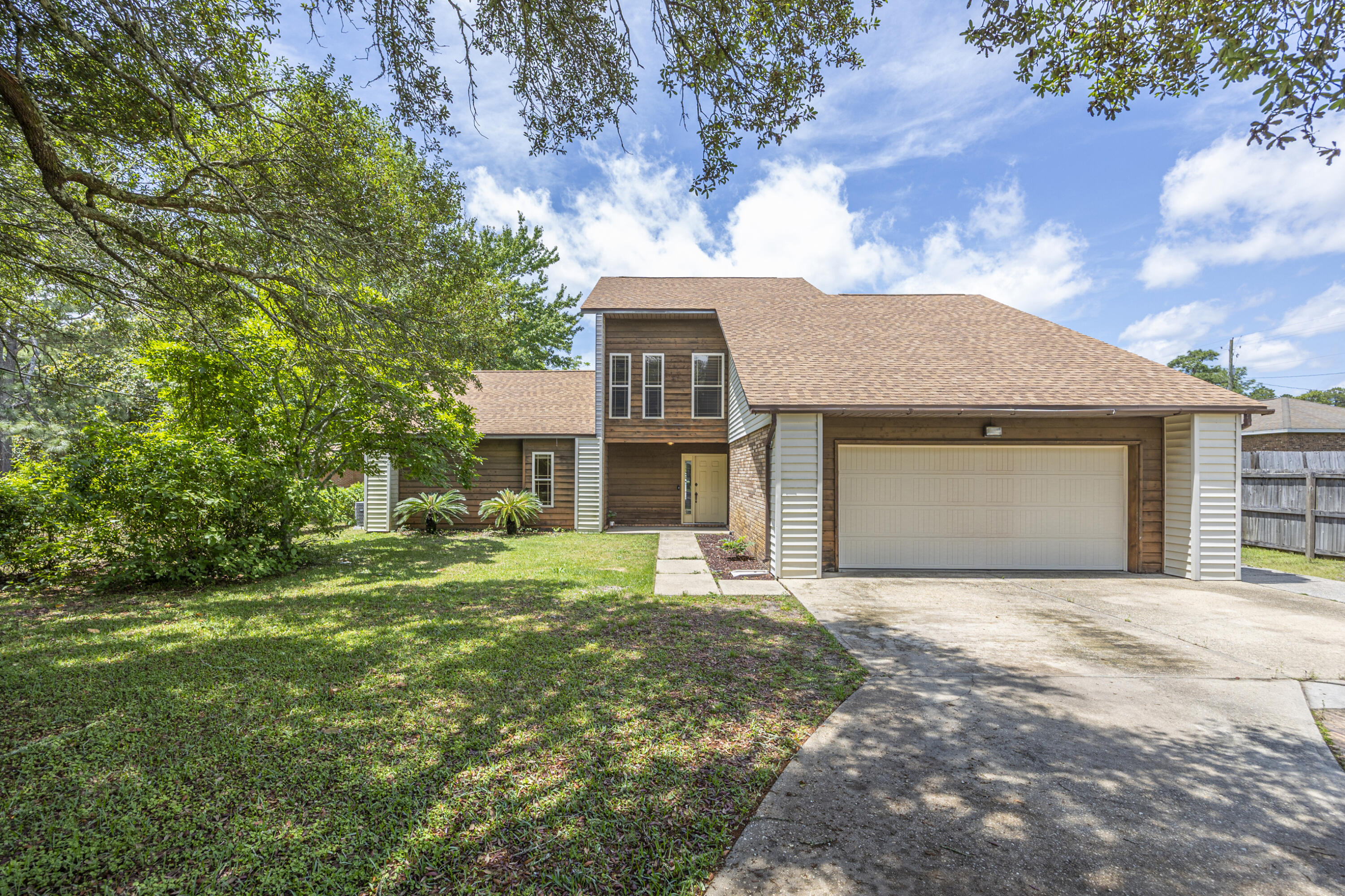 3 bed, 2 bath home with an inground pool in the Forest Heights Subdivision.  Featuring Vaulted ceilings, LVP flooring throughout the main level and carpet/tile upstairs.  The Main Level Master Bedroom walks-out to a private, patio area with a koi pond.  There is an additional bedroom and 1/2 bath on the main level with another bedroom and full bath upstairs.  The kitchen is equipped with stainless appliances and butcher block countertops.  Step outside to the back yard to enjoy the pool and plenty of outdoor living space.  A separate, detached garage/workshop with a full bath, offering excellent flexibility for hobbies, storage, or guest use. Conveniently located near military bases, schools, shopping, dining, and just a short distance to the beaches.