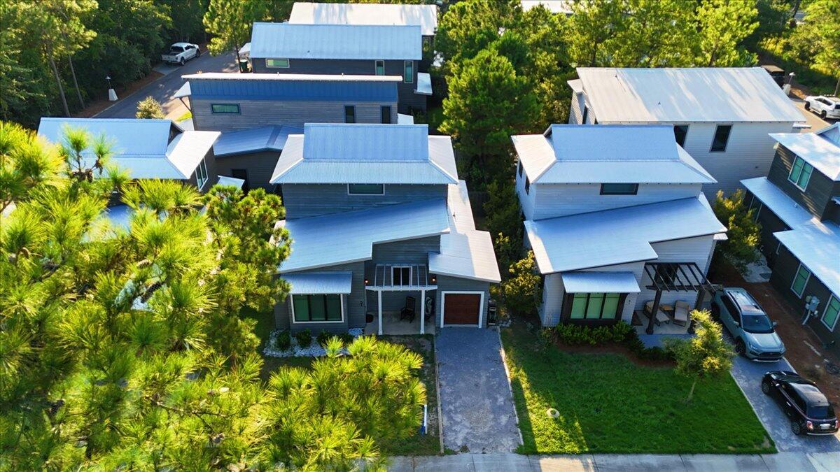 Get ready to fall in love with a home that's pure coastal-cool with a modern, high-energy twist! Located right by the lush greenery of Eden Gardens State Park, 51 Edens Landing Cir is where laid-back living meets high-end style. From the striking cedar wood siding to that charming pergola, this place has 'wow factor' written all over it.
Step inside and feel the vibe--it's airy, open, and flooded with light. The tall ceilings and warm wood floors create a space that's expansive yet perfectly cozy. If the kitchen is the heart of the home, this one is beating fast! We're talking a fully-equipped culinary playground featuring sleek stainless appliances, crisp quartz countertops, and a breakfast bar that's practically begging for morning lattes and good conversation. The main level serves up a primary suite that feels like a total getaway, complete with a spa-inspired ensuite and a walk-in closet ready for your boutique finds. Head upstairs to find two more bright bedrooms and a second full bath, giving everyone plenty of space to recharge. And because we know life is busy, the dedicated laundry room keeps everything organized and effortless. Living in the non-rental community of Eden's Landing means you've got access to a sparkling pool and the nearby Point Washington boat launch for when the water calls your name. When you're craving a little action, the boutiques and energy of Seaside and Watercolor are just a quick trip away.