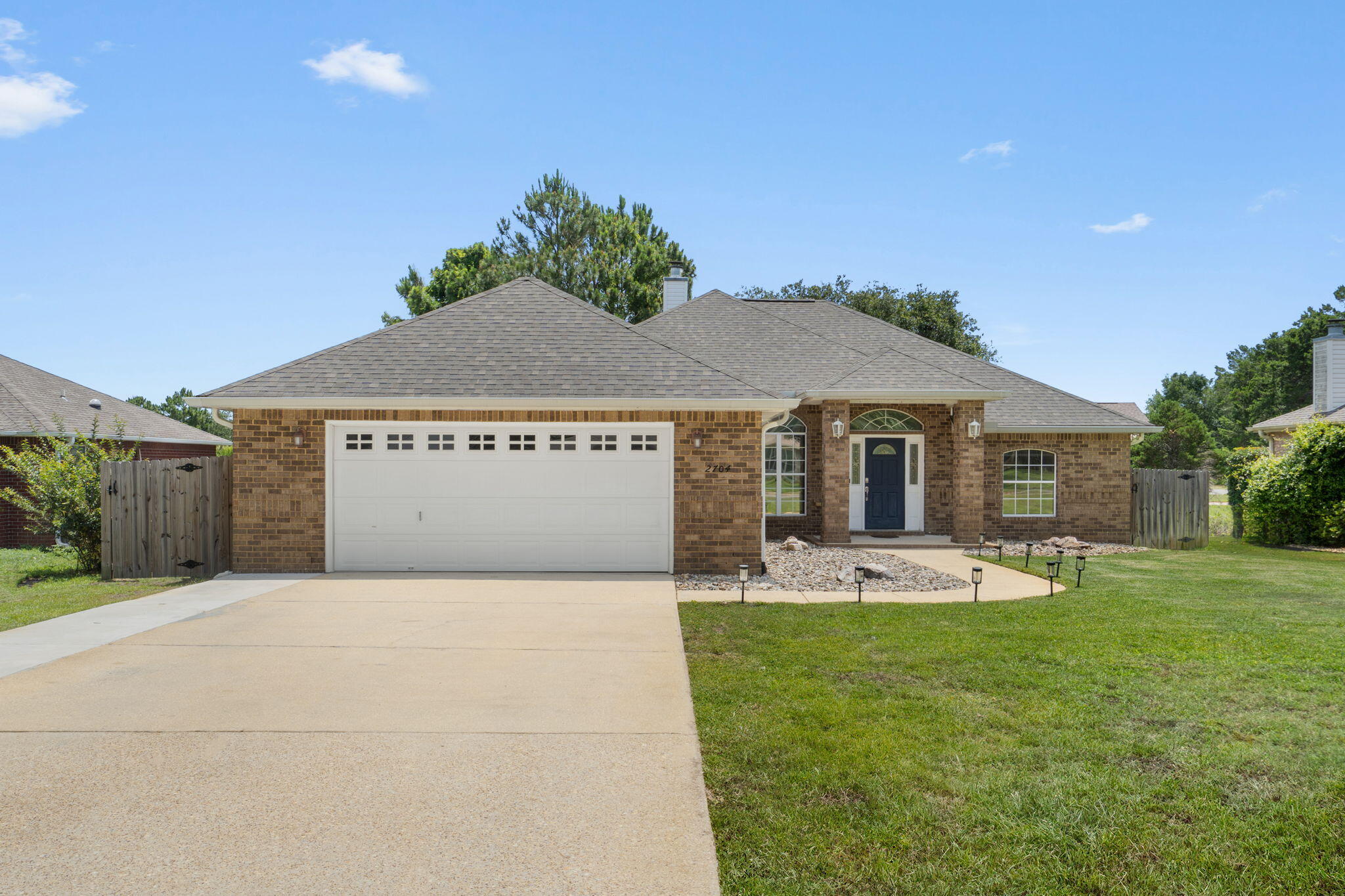 Enjoy peaceful water views from this beautifully maintained all-brick 3-bedroom, 2-bath home situated on a spacious lot along a quiet cul-de-sac in a desirable non-HOA subdivision near Hidden Creek Golf Course and just a short drive to the sugar-white sands and emerald waters of Navarre Beach. Have peace of mind knowing the major systems have already been updated, including a 2021 roof, 2019 HVAC system, and water heaters replaced in 2023 and 2025.

Inside, you'll find an open-concept floor plan enhanced by custom touches such as arched doorways, bullnose corners, crown molding throughout the common areas, tray ceilings with additional crown molding details, ceiling fans, and a cozy fireplace in the living room. Luxury vinyl plank flooring flows through the living and formal dining rooms, while tile flooring is featured in the kitchen and bathrooms. The main living area also includes a built-in dry bar with a granite countertop and storage, perfect for entertaining. As an added bonus, the mounted flat-screen TV in the living room will remain with the home.

The spacious kitchen is designed for both everyday living and entertaining, featuring granite countertops, stainless steel appliances including a French door refrigerator, soft-close drawers, drop-down pendant lighting over the breakfast bar with seating, a separate eat-in dining area, and a formal dining room for larger gatherings. The oversized walk-in pantry measures nearly 5' x 8' and includes its own utility sink for added convenience. The private primary suite offers a true retreat with surround sound wiring and a spacious en-suite bath featuring 18-inch tile flooring, double vanities, a deep garden tub, private water closet, and a walk-in, step-down tiled shower complete with a window for natural light. An additional 50-gallon water heater serves the primary bath, providing extra comfort and convenience.

Two generously sized guest bedrooms offer ample closet space and comfortable accommodations for family and guests. A separate interior laundry room comes complete with a washer, dryer, and an additional utility sink.

Just off the living room, sliding glass doors open to a bright Florida room that leads to the back patio, creating the perfect space to enjoy the surrounding views year-round. The covered patio overlooks the fishing pond and peaceful backyard setting. Beyond the privacy-fenced yard, the property extends to a tranquil fire pit area - ideal for relaxing evenings and gathering with friends while taking in the natural beauty of the landscape. Welcome home!