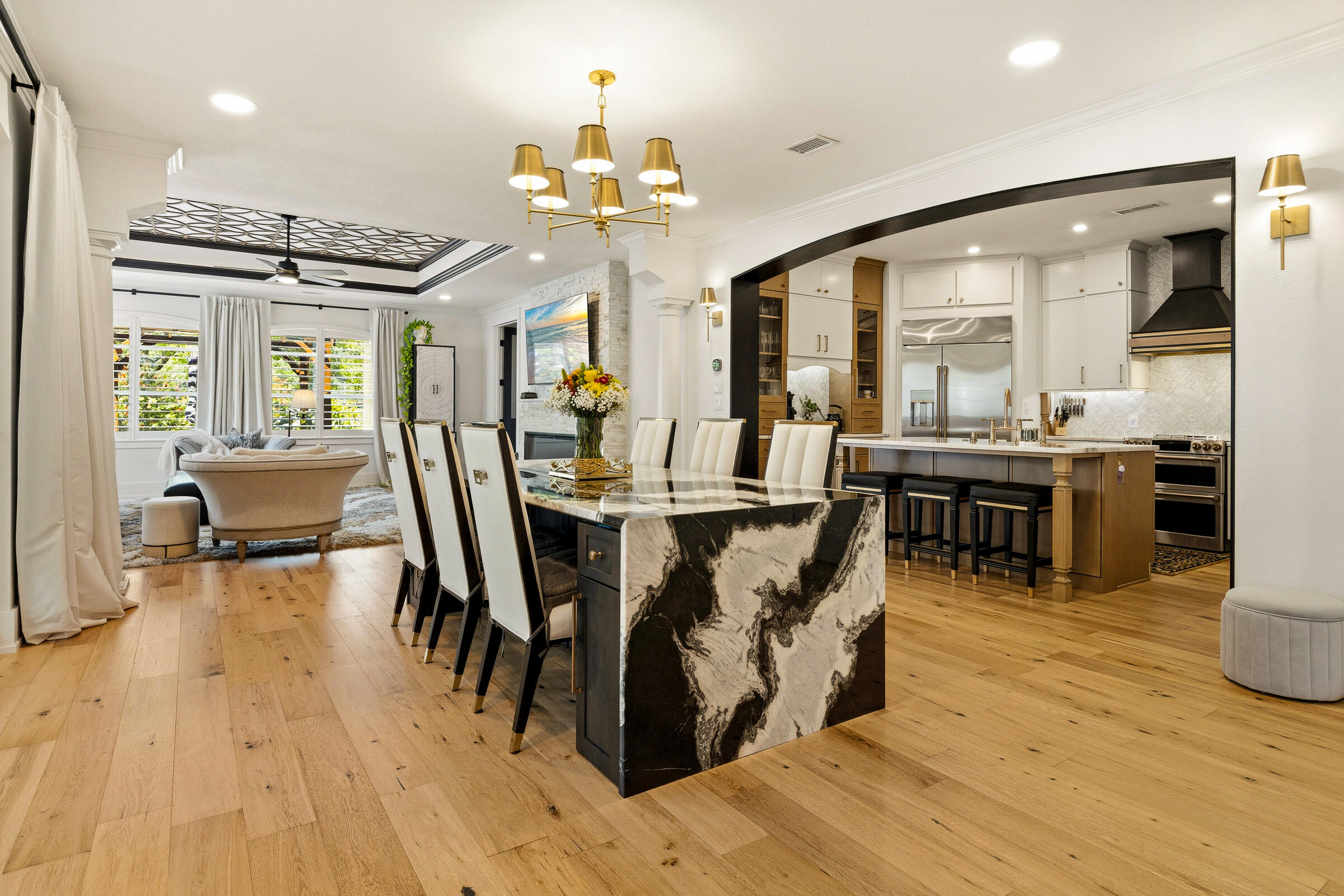Tucked within the Legend Creek neighborhood of Sandestin Golf & Beach Resort, this completely transformed residence at 8003 Legend Creek Drive is a true showcase of craftsmanship, design, and thoughtful detail. Every inch of the home has been impeccably renovated, blending elevated finishes with modern functionality to create a refined yet comfortable retreat. Offered fully furnished, this home is truly move-in ready.
From the moment you arrive, the custom mahogany front door with impact glass sets the tone for what awaits inside. Rich wood flooring flows seamlessly throughout, complemented by designer lighting, custom ceiling details, and a striking stacked stone fireplace with a 72-inch electric feature as the focal point of the living space. The home is outfitted with Sonos surround sound, adjustable ambient lighting, and curated furnishings that enhance its sophisticated aesthetic.

The fully reimagined kitchen is both stunning and highly functional, featuring double-stacked cabinetry, premium GE Café appliances, a built-in coffee niche, wine and beverage coolers, and elegant finishes throughout--perfect for both everyday living and entertaining. Just beyond, indoor and outdoor spaces connect effortlessly, leading to a beautifully redesigned patio complete with a built-in grill, TV, and inviting gathering areas.

The primary suite offers a true sense of retreat, highlighted by a spa-inspired bathroom with a whirlpool tub and dual shower, along with a custom-designed closet. Guest bedrooms have been thoughtfully updated with custom built-ins, while a newly converted, spray foam-insulated loft provides exceptional flexibility with an additional sleeping area, game center, and workspace.

Outside, the home continues to impress with professionally designed landscaping, a pergola, fountain, and ambient lighting--all anchored by a fully fenced backyard offering a rare level of privacy within the community.

Additional upgrades include impact-rated front entry and sliding glass doors, a high-capacity HVAC system with dehumidifier, recent exterior paint, a new hot water heater, and a fully outfitted garage with epoxy flooring, custom storage, and its own dedicated AC system. A new 2025 Star Sirius 4+2 Li-ion 6-seater golf cart, still under warranty, is also included--perfect for enjoying all that the resort has to offer.

This is a rare opportunity to own a truly turnkey home where no detail has been overlooked--ideal as a full-time residence, second home, or investment within one of the Emerald Coast's most sought-after resort communities.

As an introduction to the Sandestin lifestyle, we invite our new owners to explore amenities that make Sandestin special. The listing brokerage and seller(s) are presenting the buyer(s) of this property with (2) 90-minute rounds of Tennis court time, a golf foursome at one of our three championship courses, and a round of golf for up to four (4) players at the unrivaled Burnt Pine Golf Club.
Sandestin Golf and Beach Resort features more than seven miles of beaches and pristine bay front, four championship golf courses, 15 world-class tennis courts, a 226-slip marina, a fitness center, spa and celebrity chef dining. Shop, dine and play at the charming pedestrian village, The Village of Baytowne Wharf and more. Inside the gates of the resort, residents enjoy a balanced lifestyle of high-class living, spanning the 2,400 acres from the beach to the bay. Everything within the gates of the resort is accessible by golf cart or bicycle. The entire resort is interconnected by miles of pedestrian, bike and golf cart paths that weave through groves of live oaks, meandering past natural lagoons, fountains, man-made lakes, and meticulously landscaped fairways.