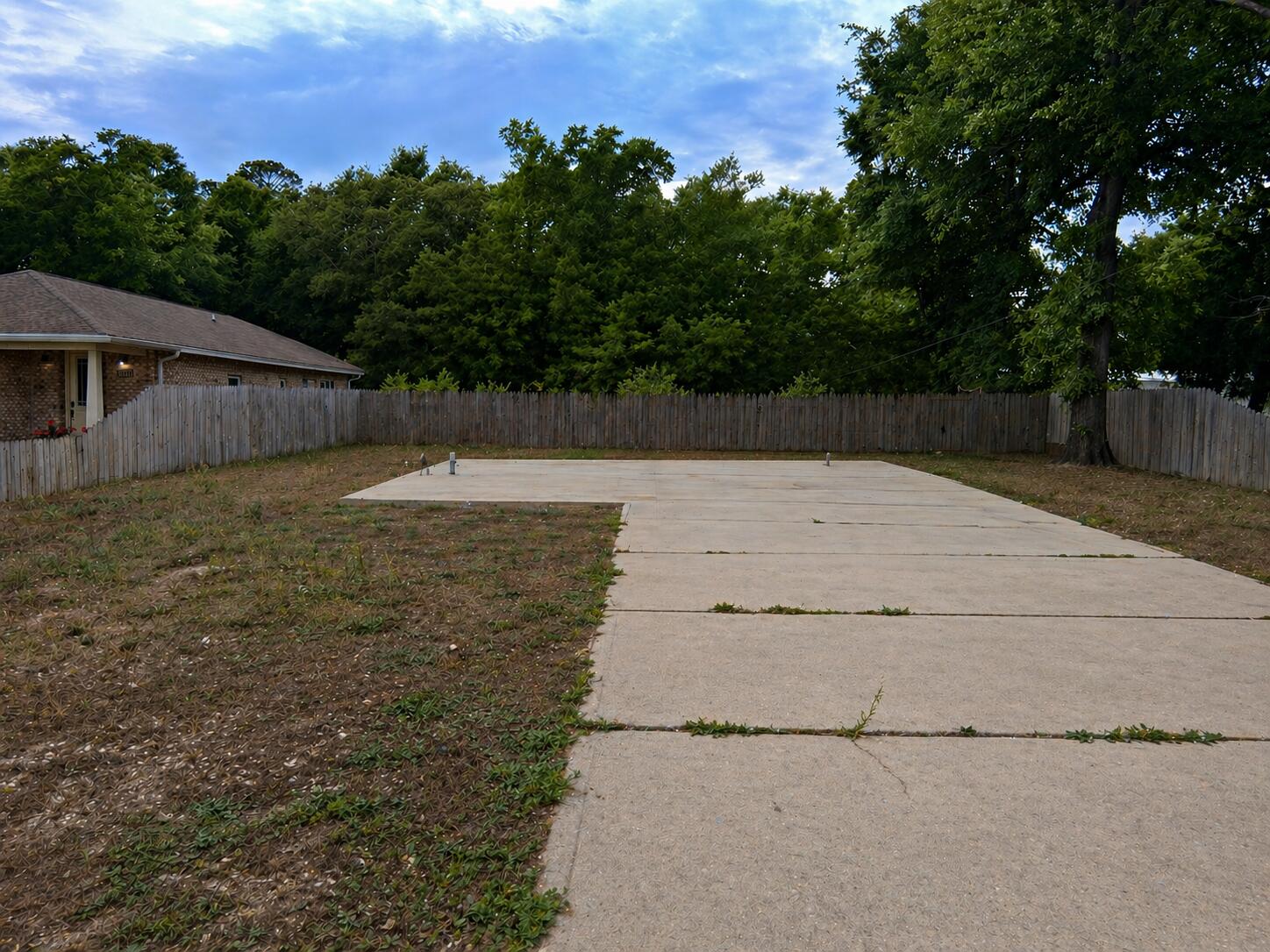 Opportunity awaits at 1438 Cedar St in Niceville, FL! This vacant residential lot in the Bluewater Bay area offers a great chance to build your new home in an established area with no HOA fees. The property includes valuable existing improvements such as the concrete slab, driveway, septic tank, and irrigation system, helping reduce some development costs and streamline the building process.

A fire-damaged structure remains on site and will need to be removed, making this an ideal project for builders, investors, or buyers ready to create a custom home from the ground up. Conveniently located near schools, shopping, dining, and the beautiful Emerald Coast beaches, this lot combines potential, location, and flexibility. Bring your plans and make it your own!