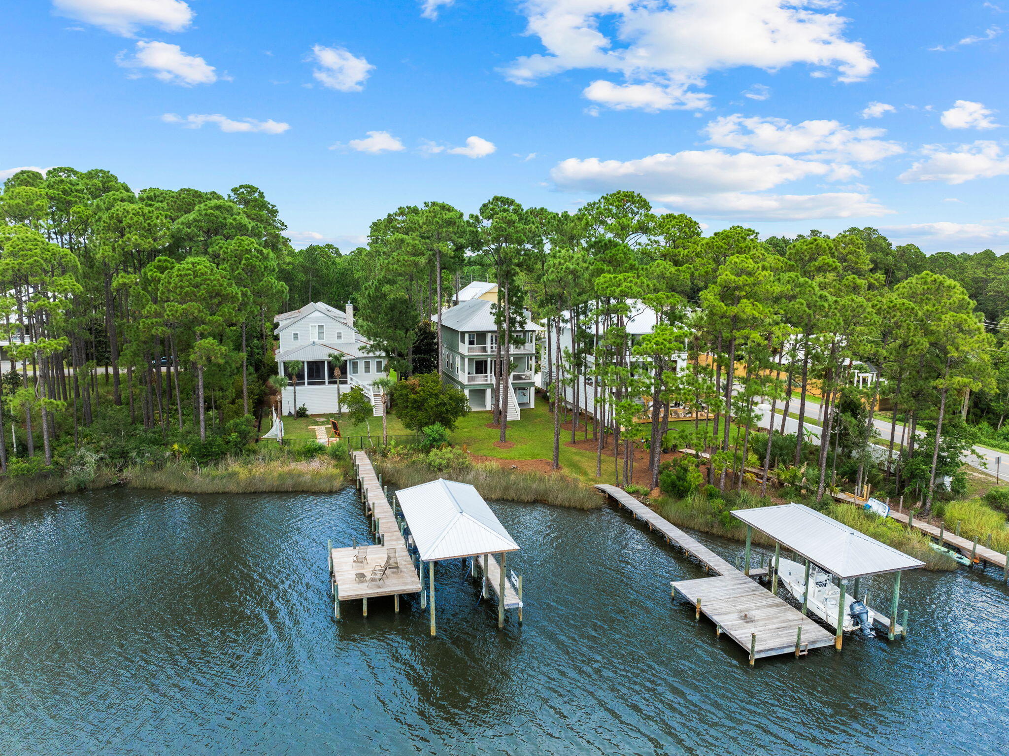 Bayfront living meets coastal charm in this picturesque residence, situated in the private, gated community of Cessna Landing. Ideally located just 3 miles from Gulf Place and 30A's beaches and positioned on the Choctawhatchee Bay, this home offers a serene setting where coastal nature abounds. The home features full-width porches on each level, including a newly screened-in porch on the main floor, providing versatile outdoor living and entertaining space. The expansive backyard banks to your private dock with Hi Tide boat lift, perfect for boating, sunsets, and quiet mornings overlooking Hogtown Bayou. The first-level garage spans the length of the home, with parking for up to three vehicles and ample storage ideal for water toys, equipment, or a home gym. Adding to the outdoor experience is a classic barrel sauna for unwinding after a day on the water or an at-home workout. Inside, the home is designed to take full advantage of bay views with a generous open floor plan and 18-foot sliding doors that bring light and warmth into the main living area. The primary suite offers water views and its own porch access, while three additional bedrooms invite plenty of space for family or guests. A wood-burning fireplace, charming cottage trim, and wired sound system throughout complete this one-of-a-kind waterfront residence.
The Cessna Landing neighborhood features a gated entrance, well-lit streets, a community pool, and a private dock, offering everything you need and more for the ultimate waterfront living experience.