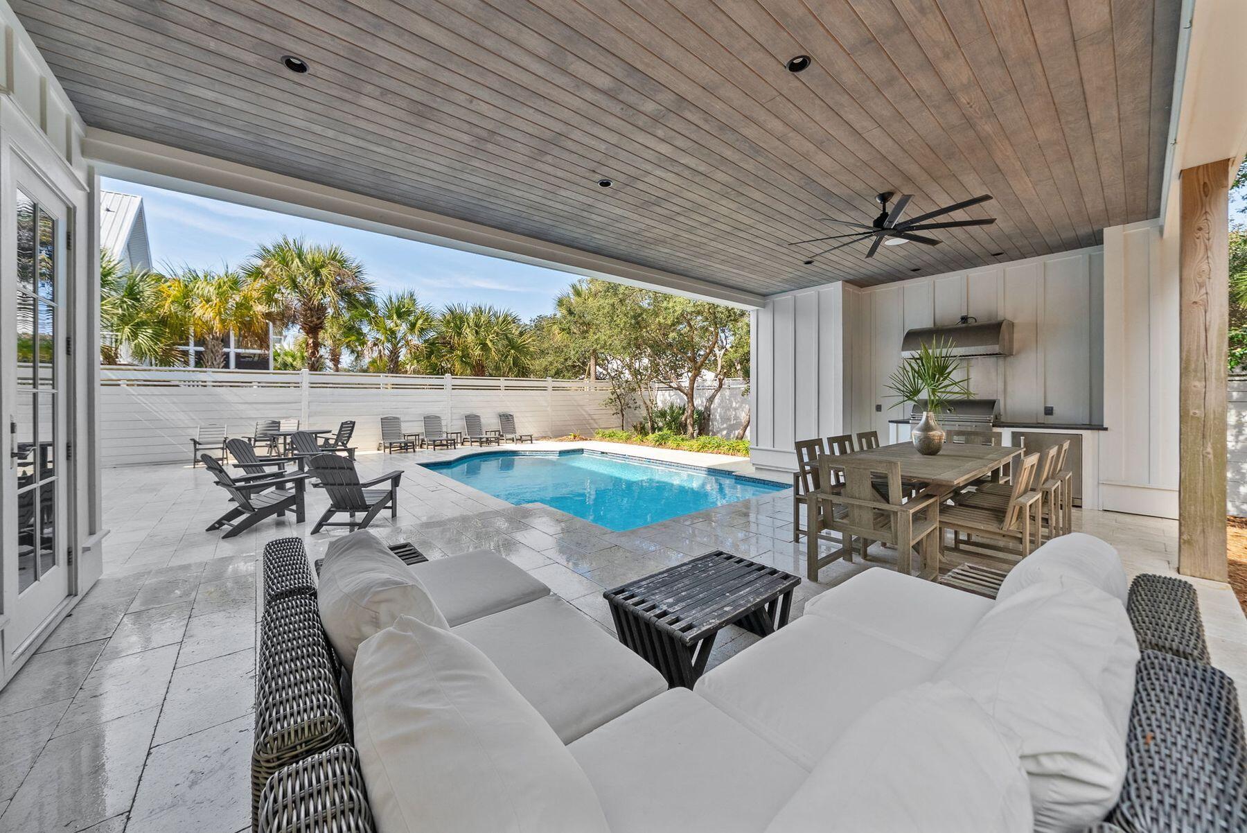 This well-appointed 7-bedroom, 7 full-bath, 3 half-bath coastal residence offers an exceptional blend of space, functionality, and prime 30A location--with no HOA and just a short walk to two public beach accesses. Thoughtfully designed for comfort and versatility, the home features two bunk areas, two separate living rooms, and multiple balconies, creating generous gathering spaces while still allowing for privacy--ideal for hosting large groups. Set on an oversized lot, the outdoor living experience is a true standout. A large heated pool, summer kitchen, and private backyard oasis shaded by mature oak trees provide the perfect setting for relaxed afternoons and evenings after the beach. The third-floor living room and kitchen serve as the heart of the home, capturing stunning Gulf views and offering a natural space for entertaining. Anchored by a 14-person dining table and ample bar seating, the chef's kitchen is equipped with stainless steel appliances, custom cabinetry, abundant storage, and designer finishes that balance style with functionality. An elevator offers convenient access to all three levels. The first floor includes a spacious mudroom with built-in cubbies and a washer and dryer, while two additional laundry areas on the upper levels make hosting guests effortless. Ideally located on the east end of 30A, between Alys Beach and The Big Chill, you're moments from dining, boutique shopping, and entertainment. With proven rental performance generating approximately $270,000-$315,000 annually, this property presents a compelling opportunity as a second home or investment along one of 30A's most sought-after corridors.