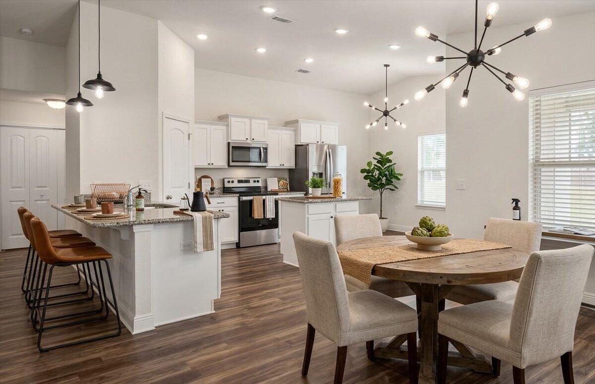 Welcome to Heather's Place Community Phase 2, a thoughtfully designed neighborhood featuring underground utilities, sidewalks, public water, and sewer, creating a clean and well-planned community environment. This energy-efficient ranch-style home offers modern comfort paired with stylish finishes throughout. Step inside to an open-concept floor plan that seamlessly connects the living, dining, and kitchen areas perfect for everyday living and entertaining. The kitchen is equipped with stainless steel appliances, including a top-of-the-line Samsung four-door refrigerator, and is beautifully finished with granite countertops that continue into both bathrooms for a cohesive, upscale feel. Luxury vinyl flooring runs through the main living and wet areas, providing both durability and contemporary style. The primary suite serves as a private retreat, featuring a soaking tub, dual vanity, separate tiled shower, and a spacious walk-in closet designed for comfort and functionality. Enjoy living in a community designed with convenience and efficiency in mind while being close to everything the area has to offer. Schedule your private showing today and come see all that this beautiful home in Heather's Place has to offer.