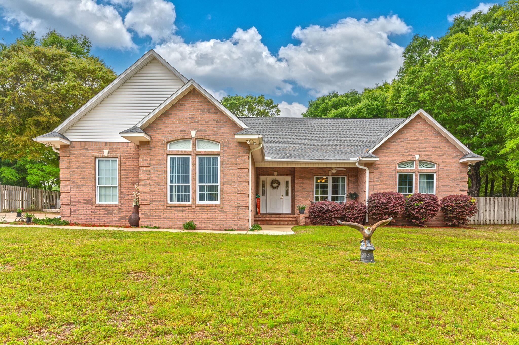 Stop the car and look no further. This meticulous maintained brick home is a must see. This one owner, custom brick home is situated on a large .59 acre lot in a well established community with wonderful waterviews. Your new home comes well equipped with a private well, irrigation system, extended driveway, an oversized garage, large porches, yard buildings for your weekend hobbies, and a large fenced in back yard that is great for the kids/pets to roam and play. The inside doesn't disappoint either with your open split bedroom floor plan. The large master suite is sure to meet your needs and hearts desires with separate shower/tub combo, dual vanity, and large walk in closet! To top things off the home got a new roof 2022, new wood look floors, some fixtures and some appliances in 2023.