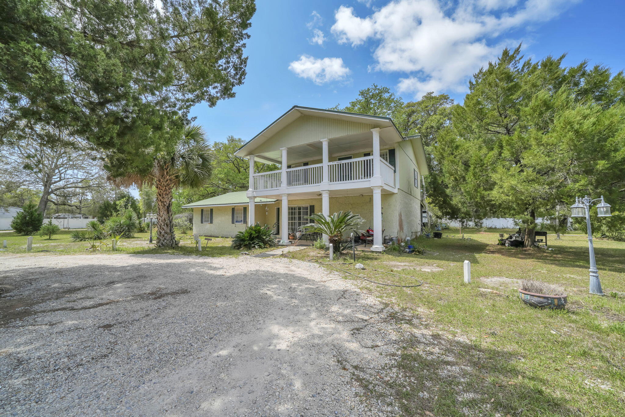 Set on 4.63 cleared acres along a paved county road, this unique property features a two-story block construction home with 5 bedrooms and 2 baths, plus an auxiliary mobile home--perfect for extended family, guests, or potential rental income. Currently used as a family compound, the layout offers flexibility for multi-generational living or a live/work setup.

With a privacy fence, quiet surroundings, and expansive usable land, there is ample room to add a workshop, business space, or storage for boats, RVs, jet skis, and more. Located within a mile of Black Creek and just minutes from the beaches and growing Freeport area, this property blends privacy, space, and opportunity in a highly desirable location.