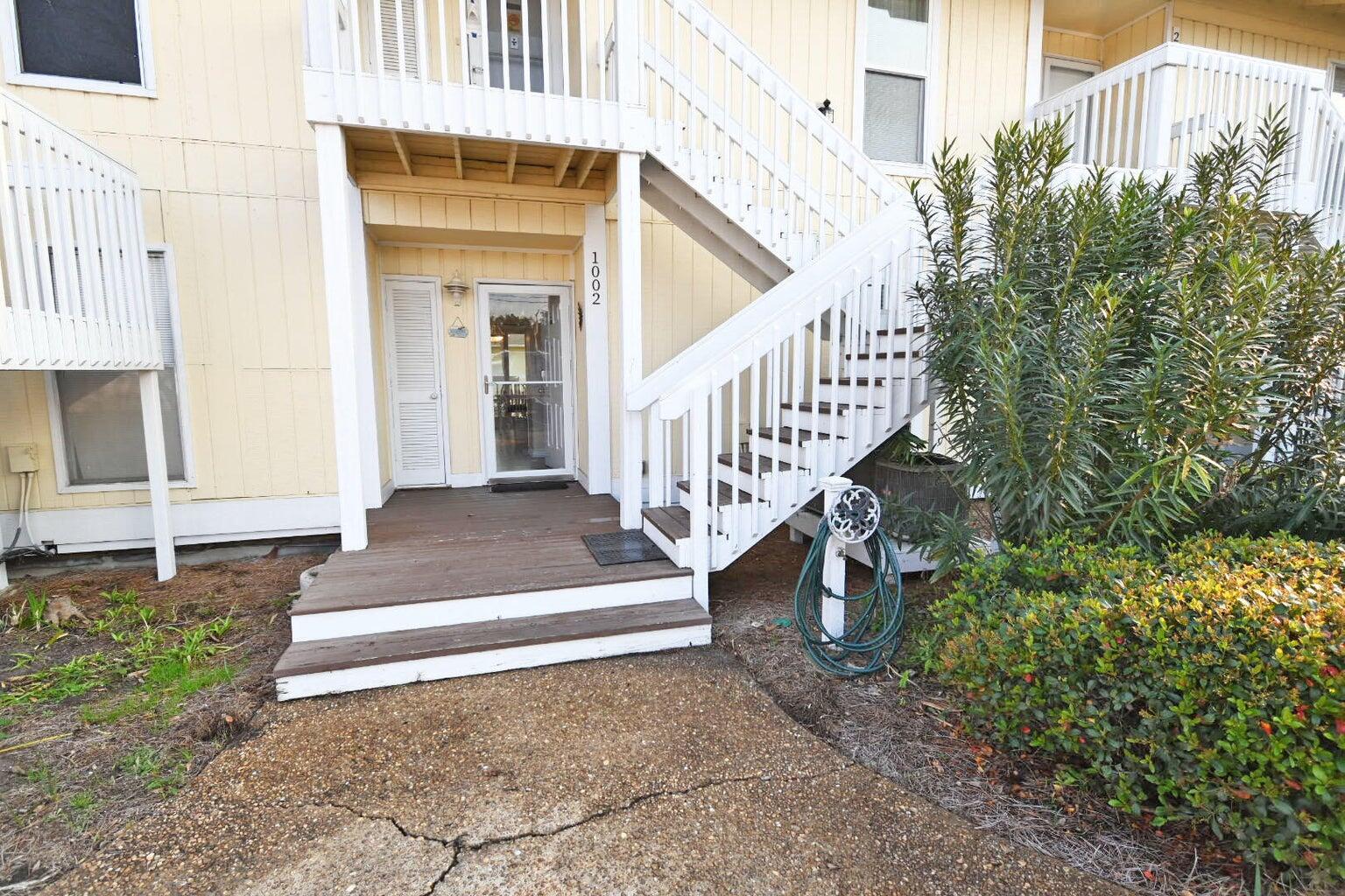 Imagine basking in the sun just moments away from the beach, where community and convenience blend seamlessly into the perfect coastal lifestyle. In this vibrant neighborhood, golf carts rule the streets, an effortless way to shuttle your beach gear, family, and friends without the hassle of carrying everything on your back. Sandpiper Cove offers convenient golf cart parking and dedicated car spaces throughout the property.  Explore the entire property, visit the various pools, or venture to the Louisiana Lagniappe on premises for a delectable meal.
Step into this charming first-floor unit, where accessibility meets comfort. With minimal steps to navigate, you'll enjoy the luxury of southern exposure on your private deck, ideal for soaking up the sun all day long. Picture yourself sipping your morning coffee under the warmth of the sun, relishing in the tranquility of your surroundings, far from the bustle of neighbors. As twilight falls, retreat to your deck for stellar views of the night sky while your laundry is just a stone's throw away, making chores feel effortless allowing you to remain in your unit while you stay comfortable while your clothes wash and dry. The property is designed with your privacy in mind and you'll appreciate the secluded area where you can stroll to your car or walk your dog in your pajamas without a care in the world.  The lower traffic area and ample parking enhance the ease of life here. The nearby activity center is just a few doors down.  Engage with fellow owners during games, dances, and various social gatherings for the Community spirit to thrive and provide excellent opportunities to make new friends.  There is a fun nine hole pitch and putt golf course too that is no charge and no need to make a tee time.  Just hop on and play. Finally, don't miss the opportunity to take the short walk down the hill and go over the quaint wooden bridge that leads you over the canal to get to the pickleball and tennis courts where friendly competition awaits. This complex is more than a residence, it's a lifestyle, perfectly situated for both relaxation and community engagement.