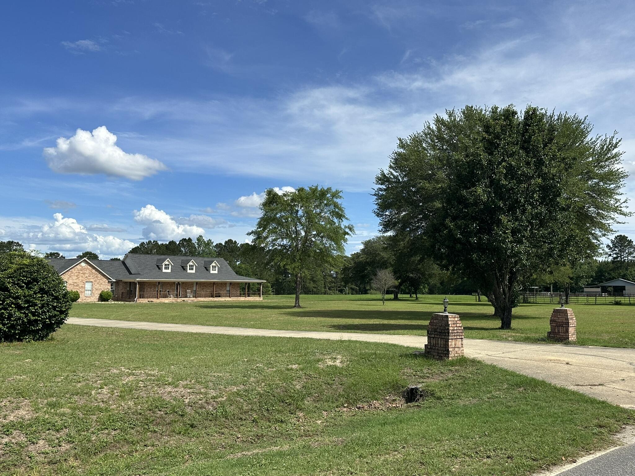 Shown by appointment only. Expansive 230+/- acre farm and recreational retreat in the Laurel Hill, Florida and Florala, Alabama area, thoughtfully set up for both cattle and equestrian use. The land is fully fenced and cross-fenced with established pasture, complemented by multiple shooting houses and food plots, making it well-suited for both agricultural and recreational use. A large pond and multiple flowing creeks enhance both function and natural beauty, while mature, towering oak trees add to the character of the property.
A lighted horse arena and well-equipped barn with game cleaning station support a variety of agricultural and outdoor pursuits. The primary residence offers a welcoming layout with 3 bedrooms, 2 baths, an open living and kitchen design, oversized mudroom and laundry space, and spacious front and rear porches. A separate 3 bedroom, 1 bath cabin provides space for guests or weekend use, complete with its own entertainment area and fish cleaning station.

The property is located just minutes from Laurel Hill, with access to Lake Jackson in Florala, shopping in Crestview, Florida, I-10 corridor access, Destin beaches, and area military bases. The offering also includes two additional parcels located in Laurel Hill, Florida, accessed through the Alabama acreage. Portions of the property may include wetlands and natural water features.