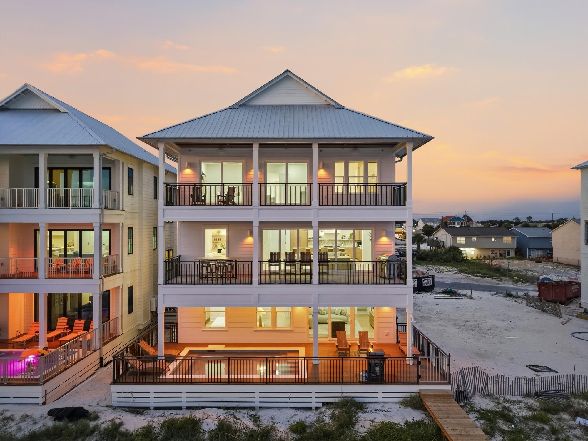 There is a certain magic to living where the Gulf is always in view. At 5931 Gulf Drive, every day begins with the horizon stretching beyond your windows and ends with sunsets that paint the sky in remarkable color. Situated within Hadley's Beach, an intimate beachfront community where only ten residences enjoy direct Gulf frontage, this fully furnished home offers a rare opportunity to experience life just steps from the sugar-white sand and emerald waters of Panama City Beach.

Encompassing 5,031 square feet, the residence was thoughtfully designed to celebrate its extraordinary setting. Expansive windows invite natural light into every level, while panoramic views of the Gulf become a constant backdrop to daily life. The home's open, flowing design creates an effortless connection between indoor and outdoor living, allowing the beauty of the coastline to take center stage.

The main living spaces were created with gathering in mind. A beautifully appointed kitchen featuring premium appliances anchors the home, opening seamlessly to spacious dining and living areas where conversations linger, celebrations unfold, and every meal is accompanied by the ever-changing beauty of the water beyond.
 Offering seven bedrooms and eight-and-a-half bathrooms, the home provides generous accommodations without sacrificing comfort or privacy. The third-floor primary suite serves as a peaceful sanctuary, elevated above the shoreline with sweeping Gulf views that transform ordinary mornings into unforgettable moments and evenings into front-row seats for spectacular sunsets.

Outside, the coastal lifestyle unfolds naturally. A private pool offers the perfect place to unwind after a day on the beach, while the Gulf is only steps away, inviting morning walks along the shoreline and afternoons spent in the turquoise waters. An elevator connects every level with ease, and two laundry rooms add thoughtful convenience to the home's spacious design.

With short-term rentals permitted, the residence offers exceptional flexibility while remaining an extraordinary place to gather, relax, and create lasting memories. Offered fully furnished, every detail has been thoughtfully prepared so the next chapter can begin from the moment you arrive.

At 5931 Gulf Drive, the Gulf is more than a spectacular backdrop--it becomes the centerpiece of everyday living, where timeless coastal beauty and effortless luxury come together in one unforgettable beachfront home.