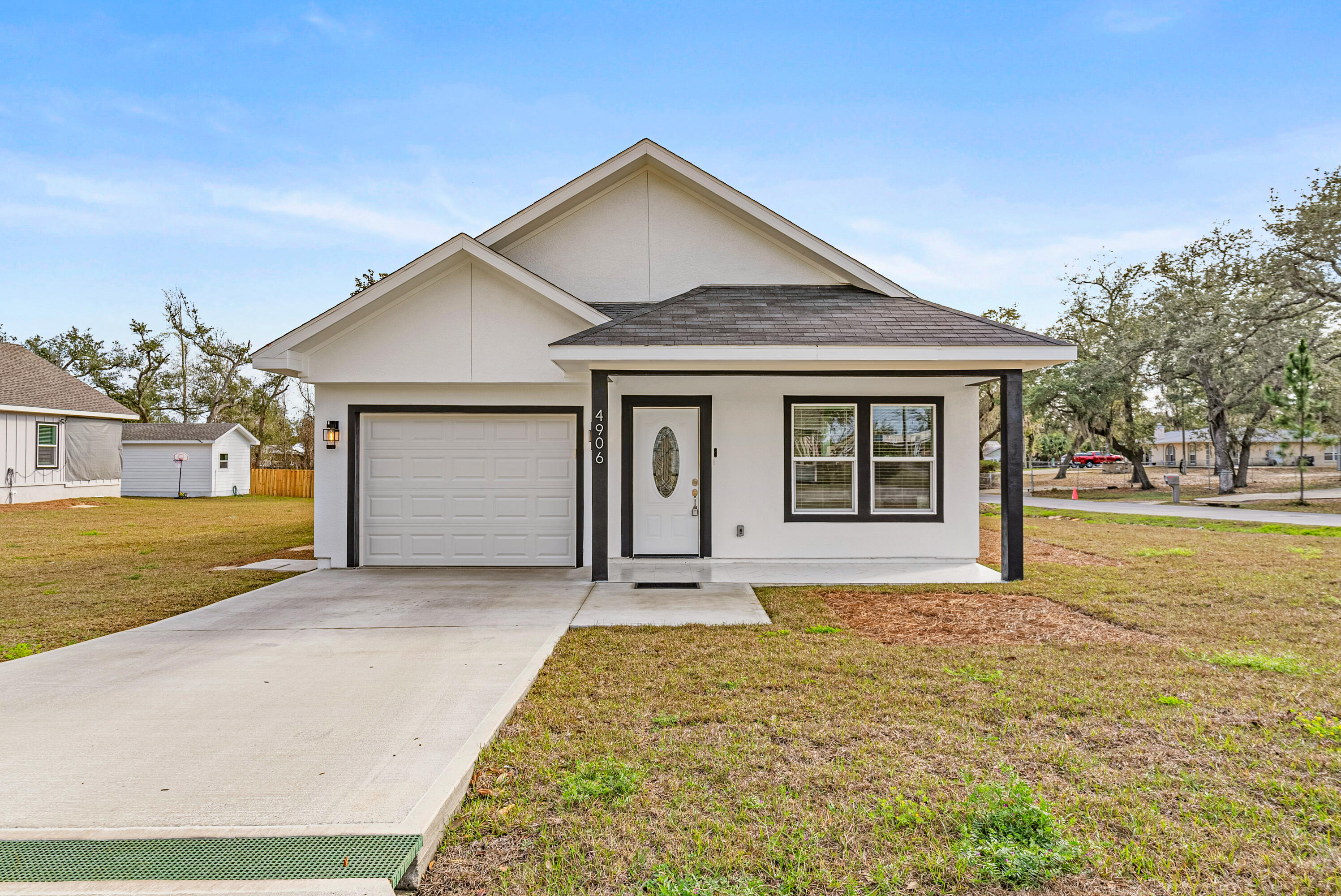 Modern Farmhouse on a Corner Lot, walking Distance to the Boat Ramp! Stunning, thoughtfully designed with high-end finishes and exceptional craftsmanship. Offering 3 spacious bedrooms and 2 beautifully appointed bathrooms, plus a third additional full  bathroom on back of the house area, this home features tile flooring throughout, creating a seamless and elegant flow from room to room. Step inside to admire the vaulted ceilings and hurricane-protected windows, providing both natural light and peace of mind. The gourmet kitchen is a dream, showcasing white granite countertops, soft-close cabinetry, stainless steel appliances, a deep sink, stylish backsplash, recessed lighting, and a spacious walk-in pantry perfect for everyday living and entertaining Enjoy Florida living at its finest on the open back porch, complete with a fully equipped outdoor kitchen featuring deep sink, stove/grill, storage. Ideal for gatherings, grilling, and relaxing year-round.
The floor plan includes a spacious master suite with an elegant tray ceiling. The master bathroom offers a walk-in shower with tile-accented walls, a large walk-in closet, and beautiful French doors that open directly onto the back porch, creating a seamless indoor-outdoor retreat.
An additional bonus area with its own full bath and tile flooring provides incredible versatility--perfect as a guest suite, home office, gym, or hobby space.
This modern farmhouse blends style, comfort, and functionality, making it the perfect place to call home.